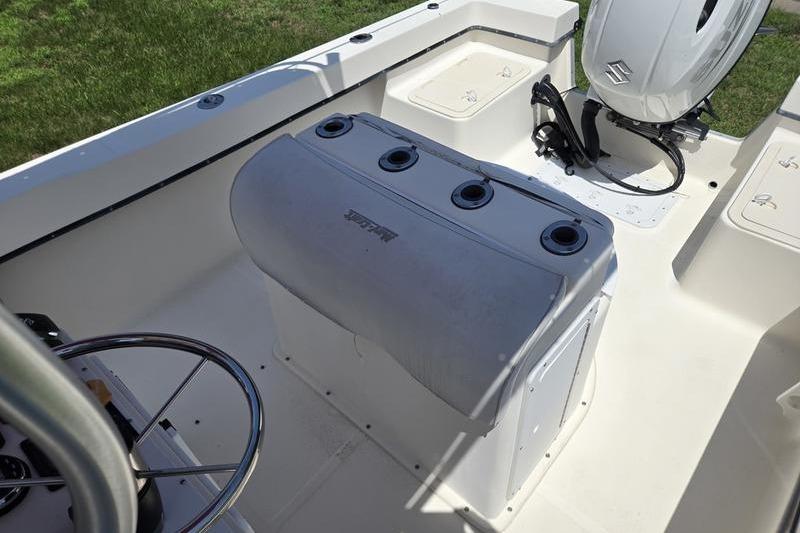 May-Craft 2000CC boat interior with steering wheel and Suzuki outboard motor.