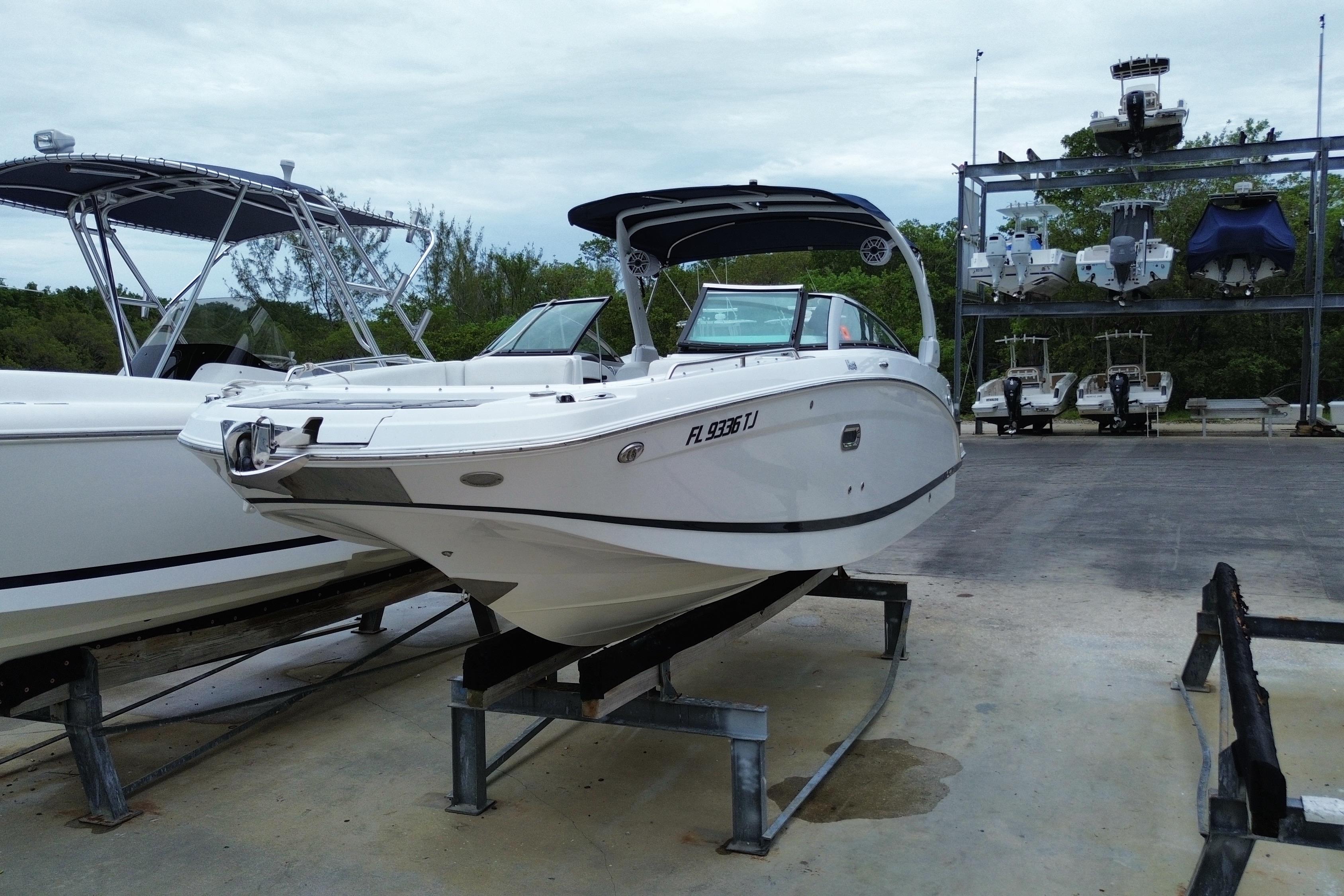 2022 Four Winns HD8 OB boat on a lift at a marina, ready for use.