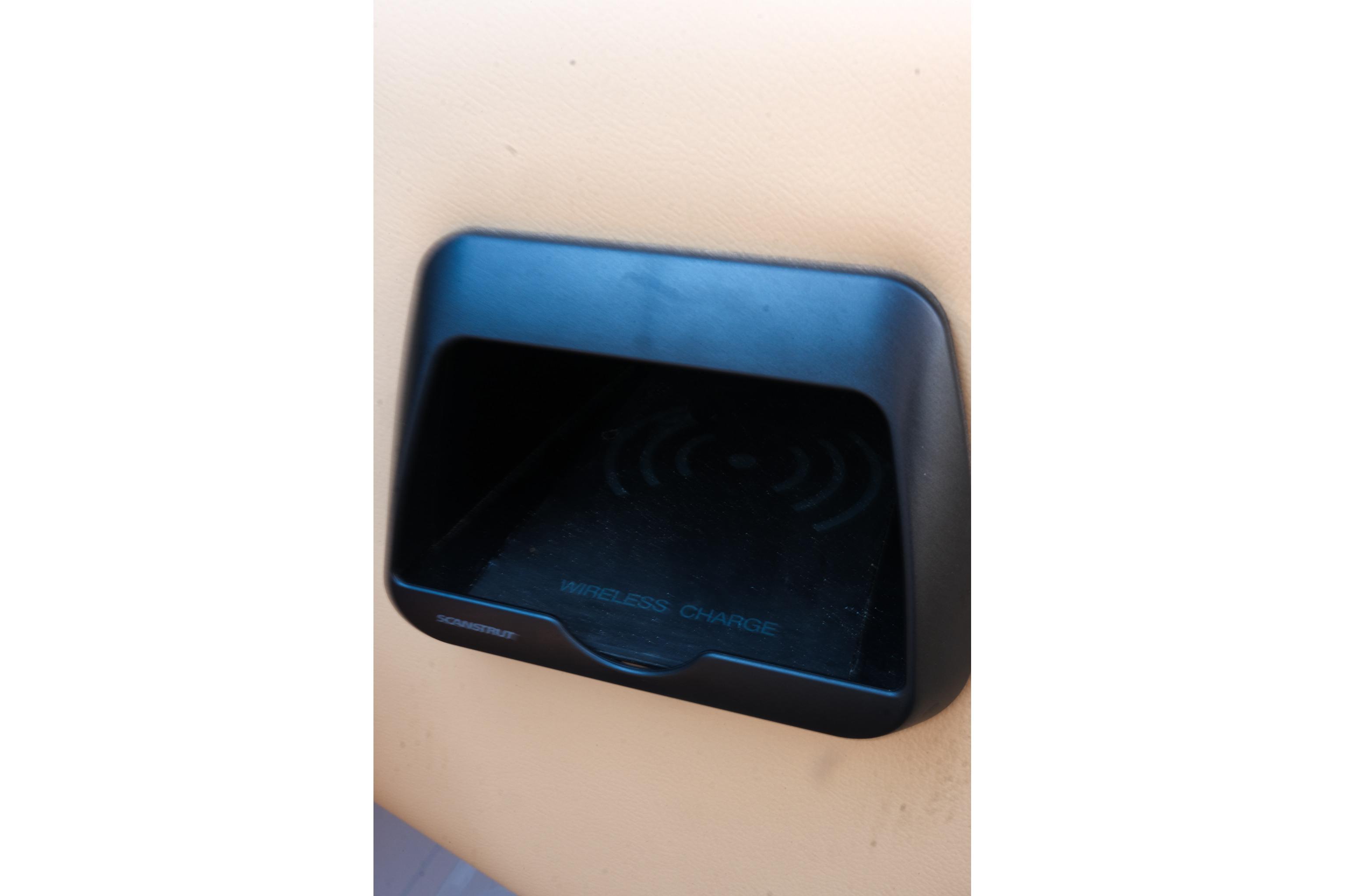 2023 Moomba Mondo wireless charging station, black, integrated into beige interior.