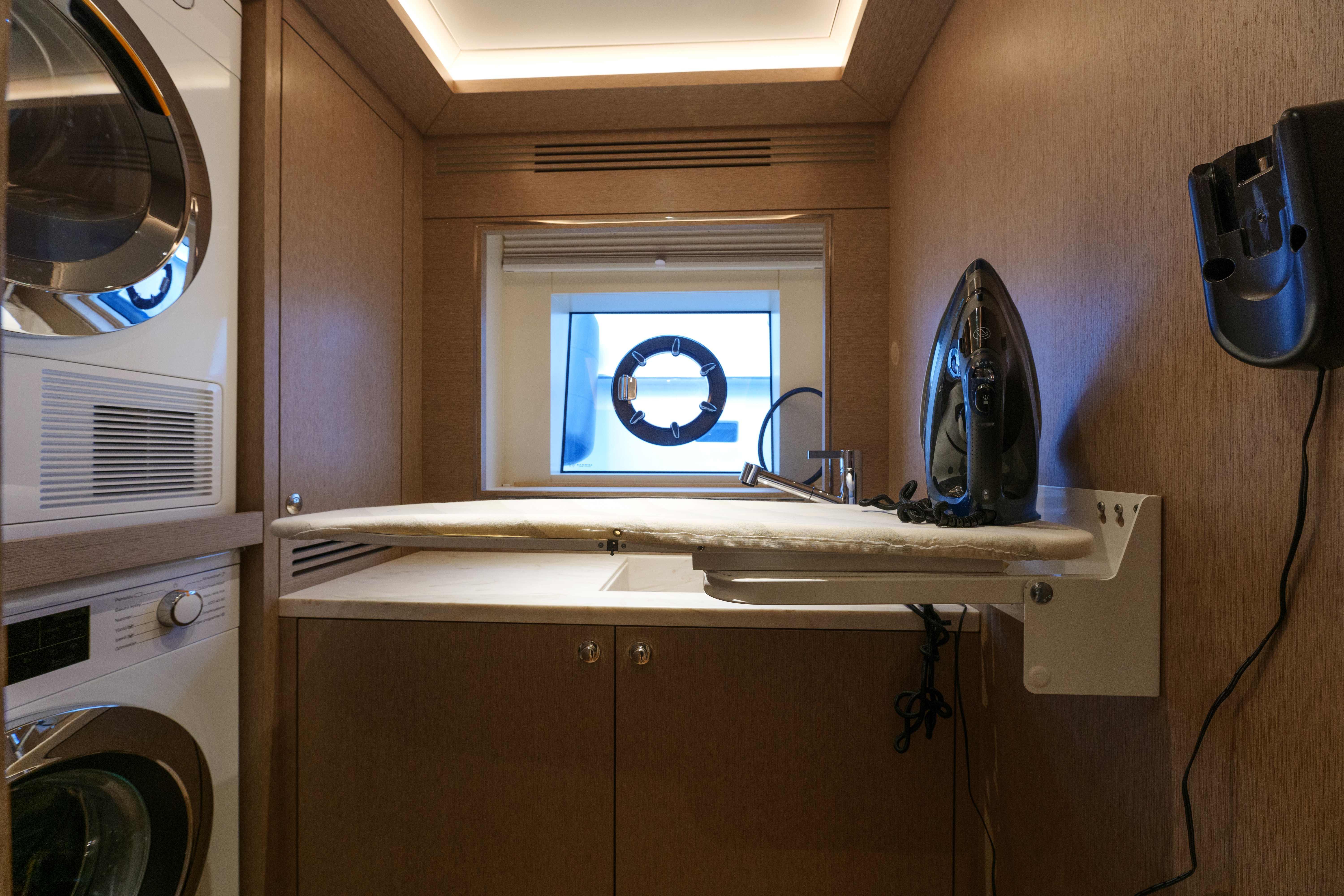 Laundry room with ironing board in 2024 Sirena 88 yacht.