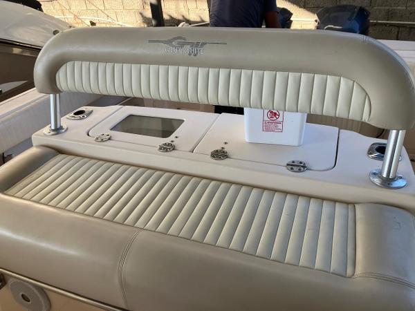 2006 Grady-White Bimini 306 boat interior with cushioned seating and control panel.