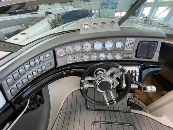 Dashboard of a 2005 Cobalt 343 boat with gauges and steering wheel.