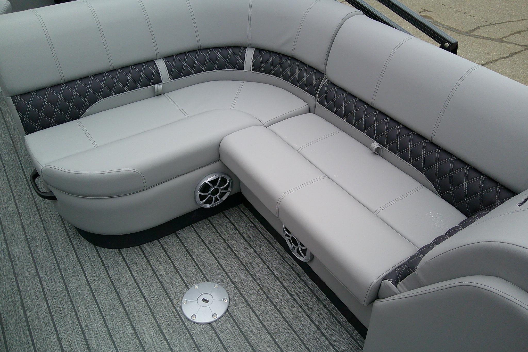 Luxurious seating on 2026 Ranger 220F boat with stylish upholstery and integrated speakers.