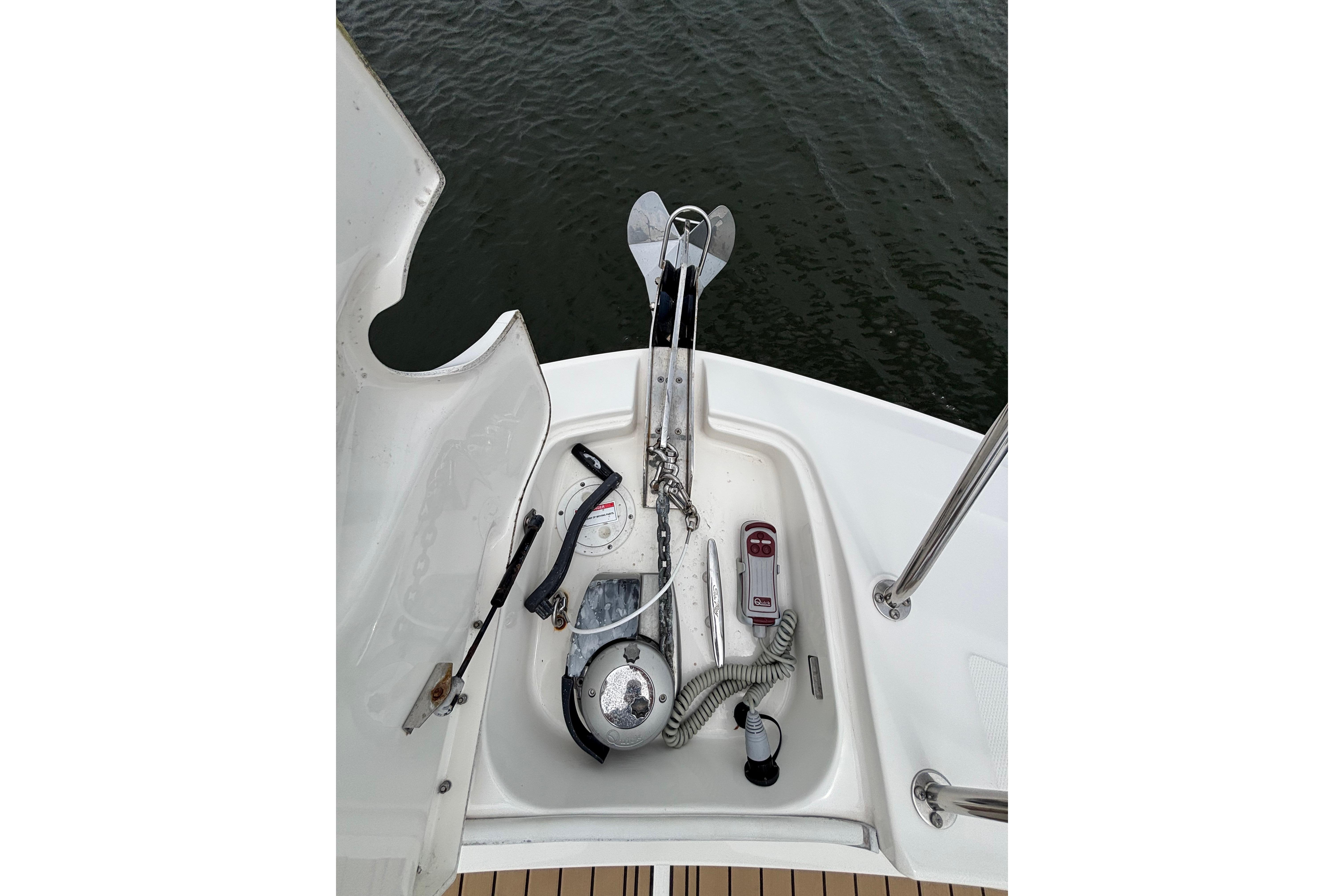 2021 Sea Ray Sundancer 320 Outboard anchor system on deck, near water.