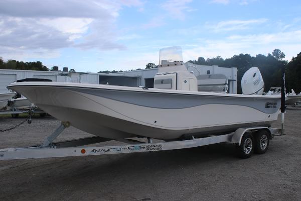 2025 Carolina Skiff 23 LS boat on trailer, parked outdoors under cloudy sky.