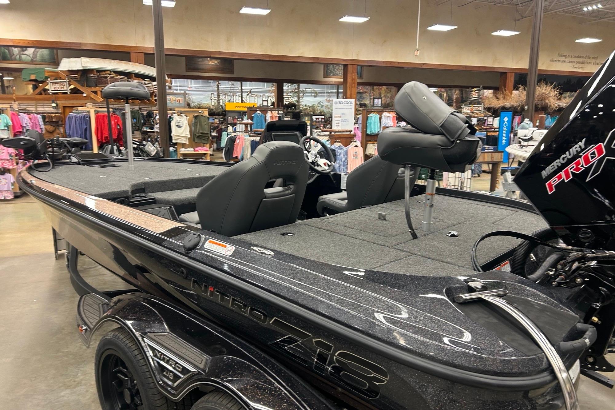 2026 Nitro Z18 Pro fishing boat displayed indoors, featuring Mercury Pro engine.