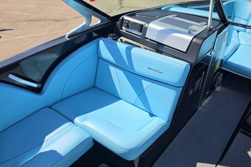 2017 MasterCraft X23 boat interior with blue seating and modern dashboard.