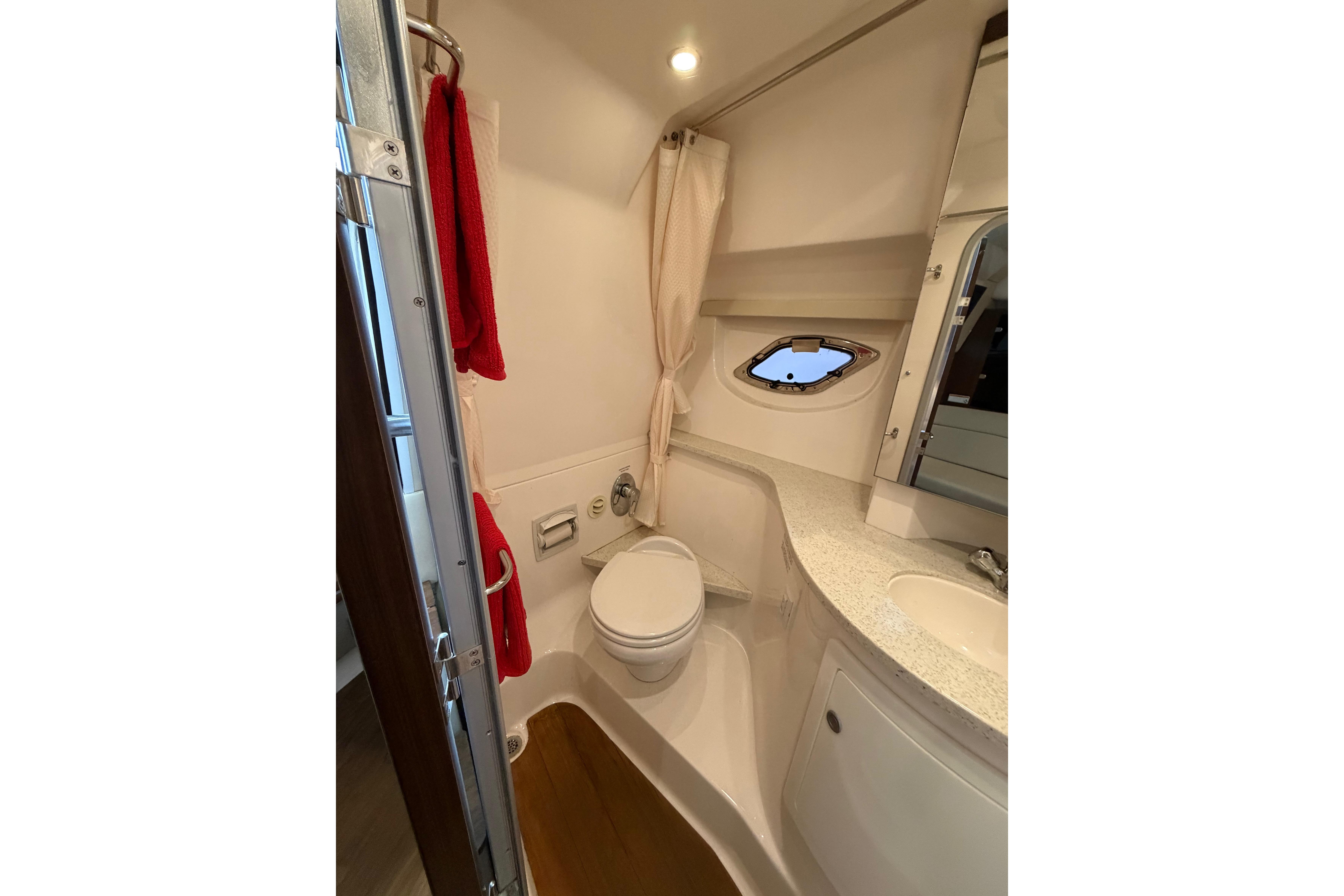 Bathroom interior of 2016 Regal 35 Sport Coupe with modern fixtures and porthole window.