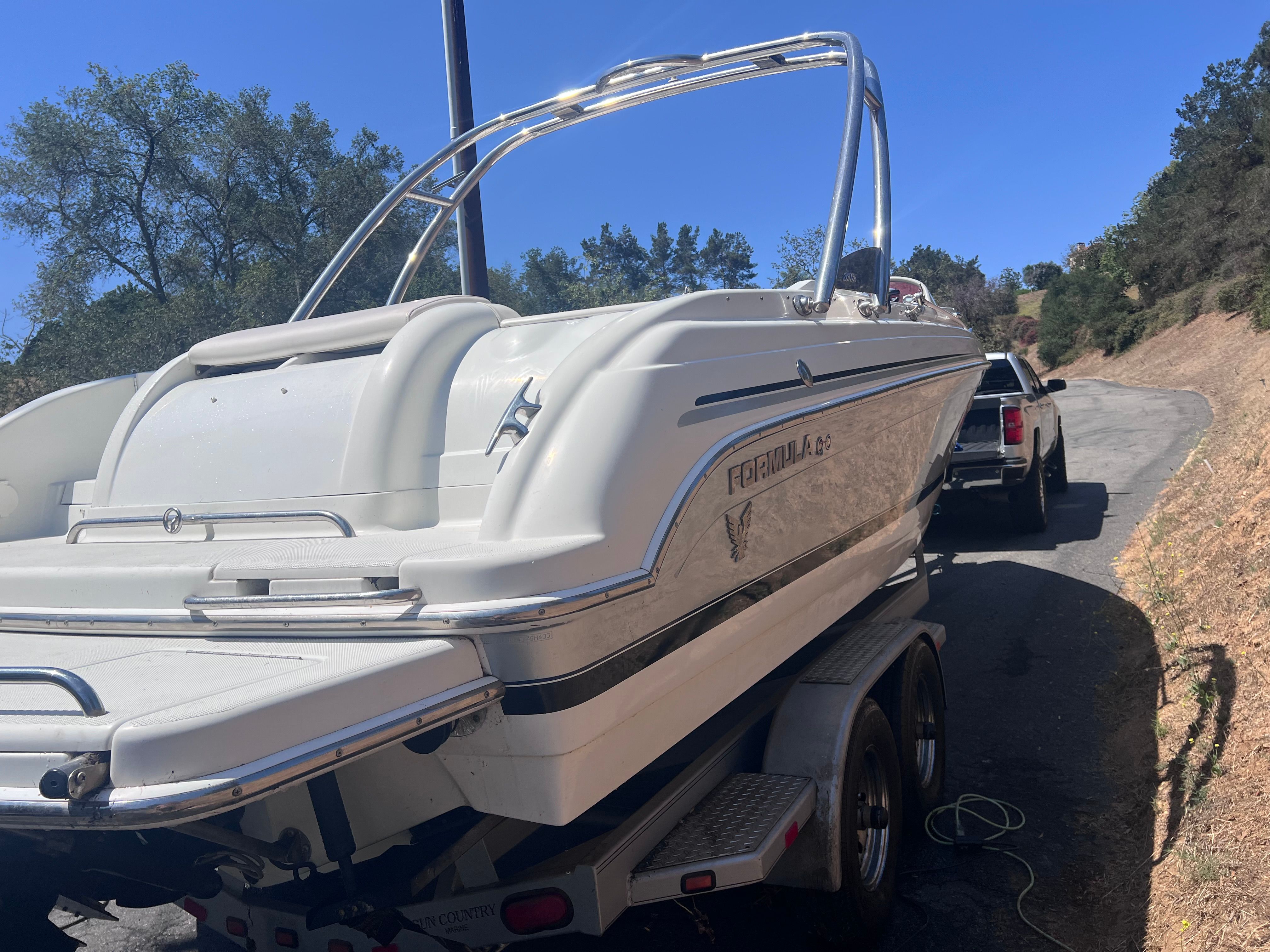 2006 Formula 260 Sun Sport boat on trailer, sunny day.