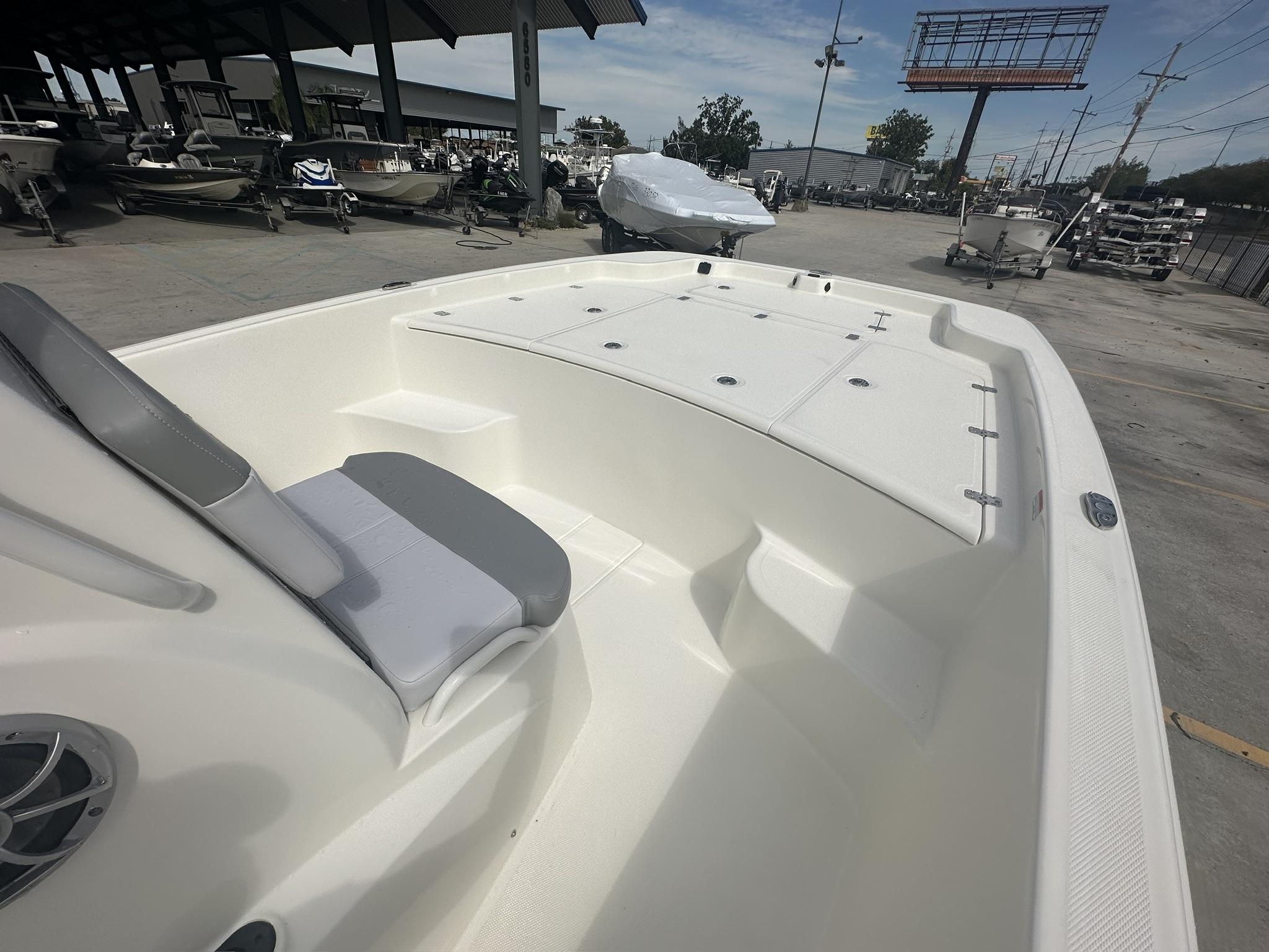2024 Mako Pro Skiff 19 CC boat interior with seating and storage compartments.