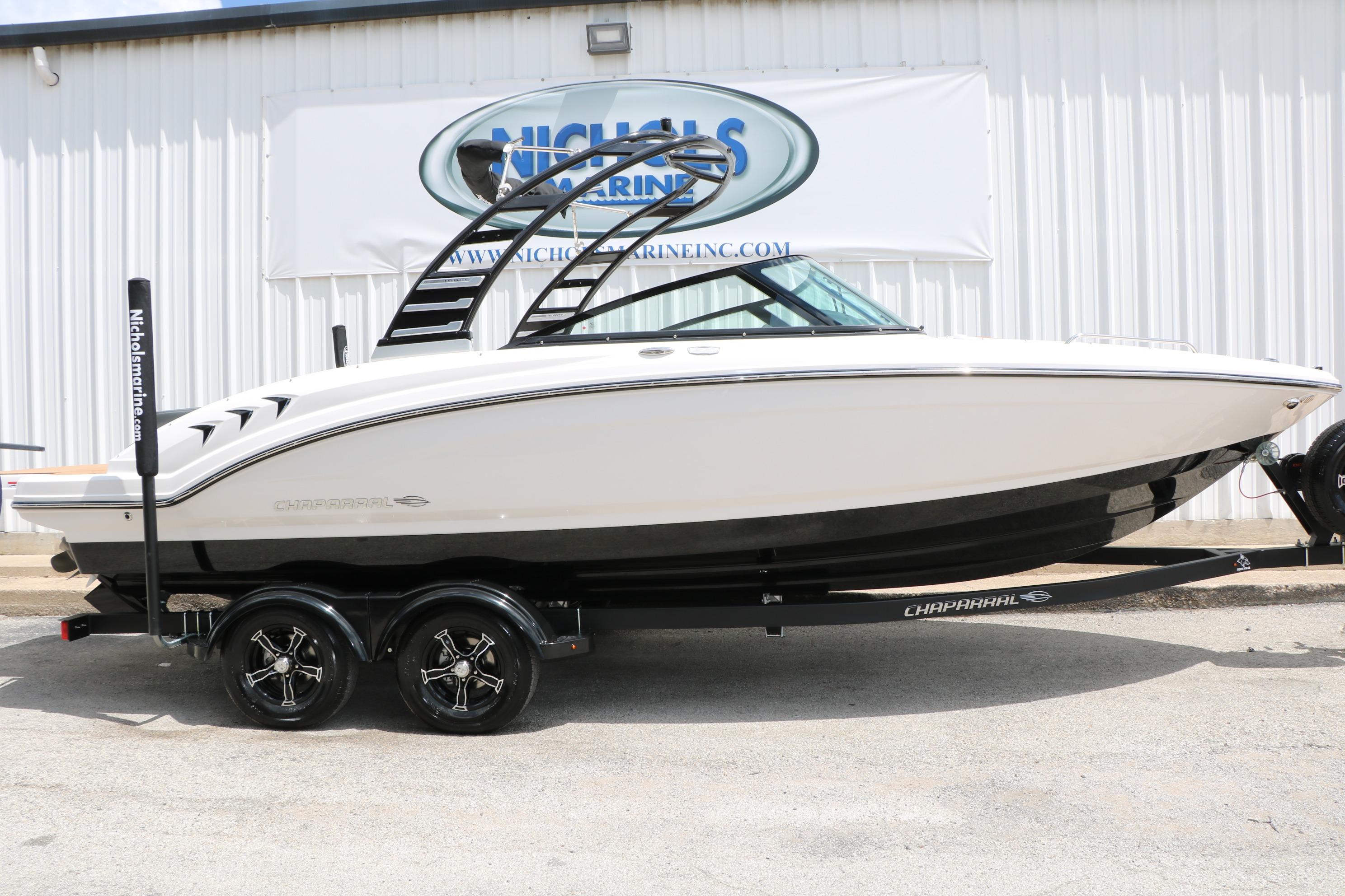 2025 Chaparral 23 SSi boat on trailer, displayed outside a marine dealership.