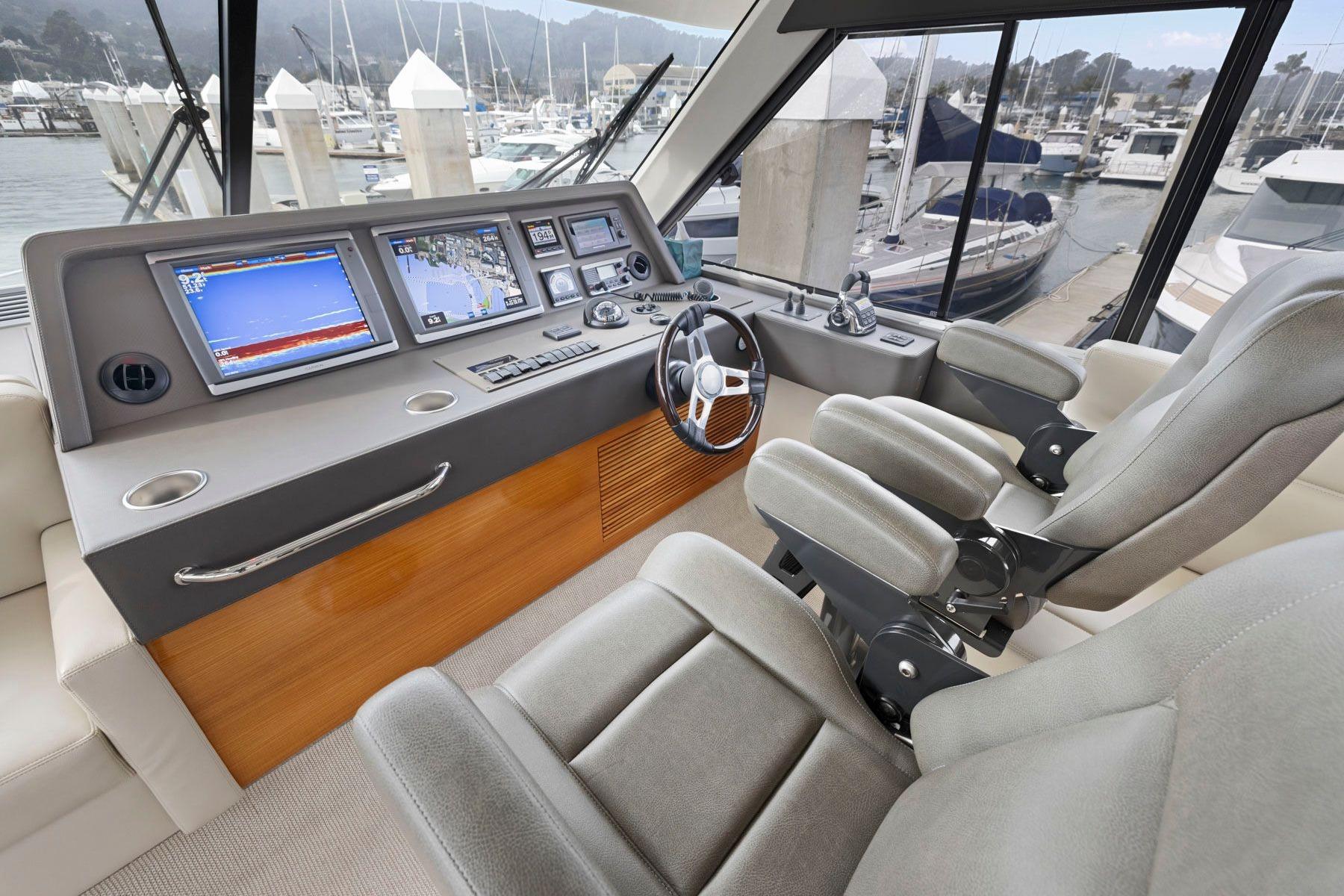 Luxurious 2014 Maritimo M50 yacht helm with advanced navigation systems and plush seating.