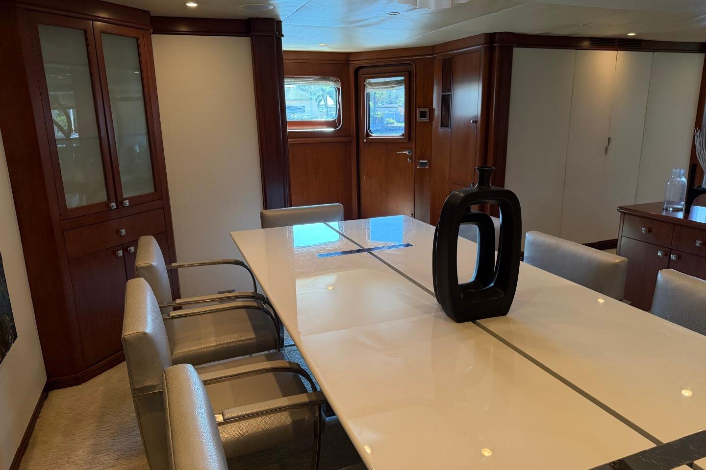 Luxurious dining area on a 1990 Heesen 144 yacht with elegant decor.