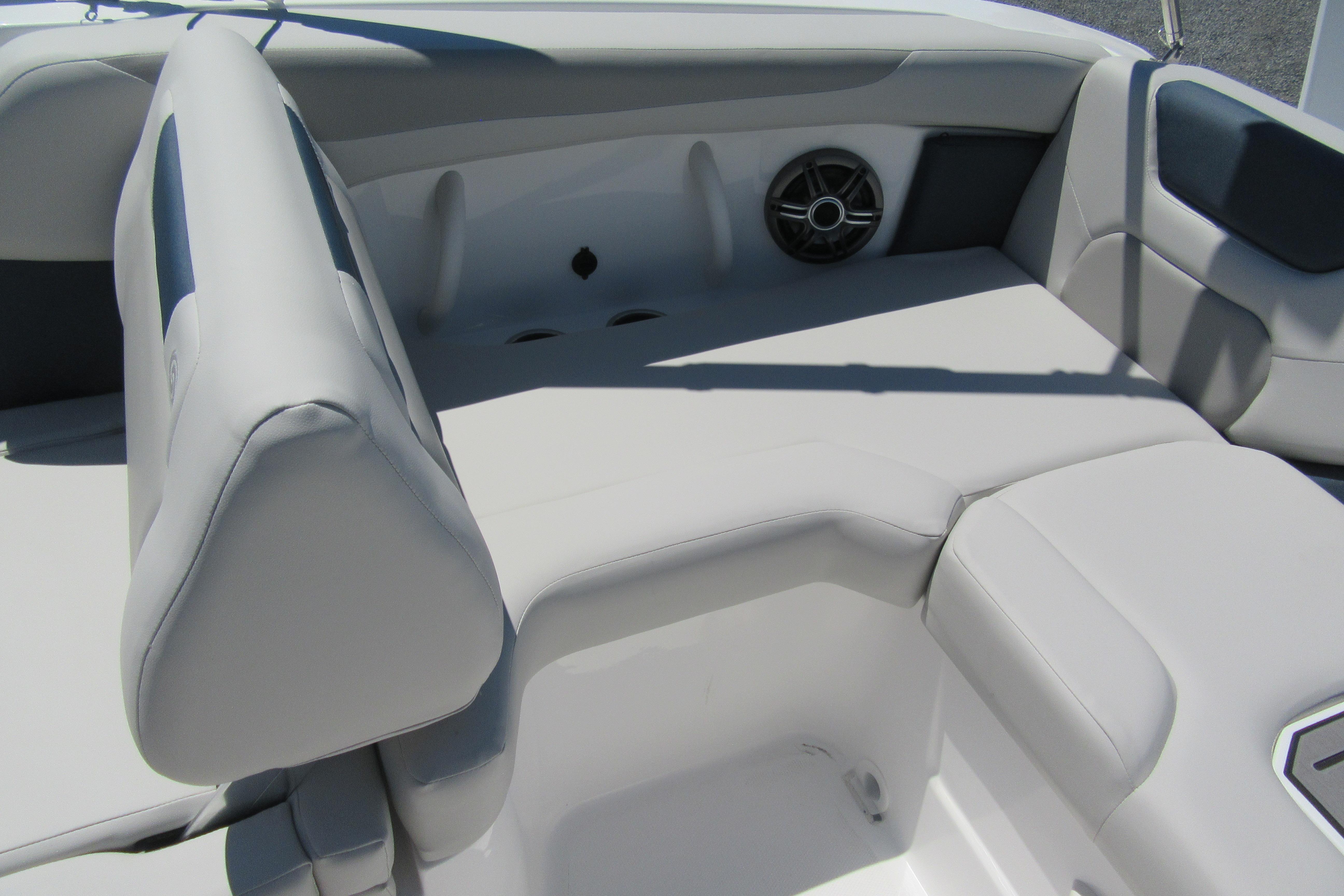 2027 Hurricane SunDeck 2050 OB boat interior with cushioned seating and speaker.