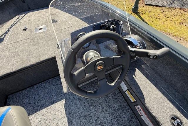 Steering console of 2026 Ranger VS1665SC boat with modern controls and carpeted interior.