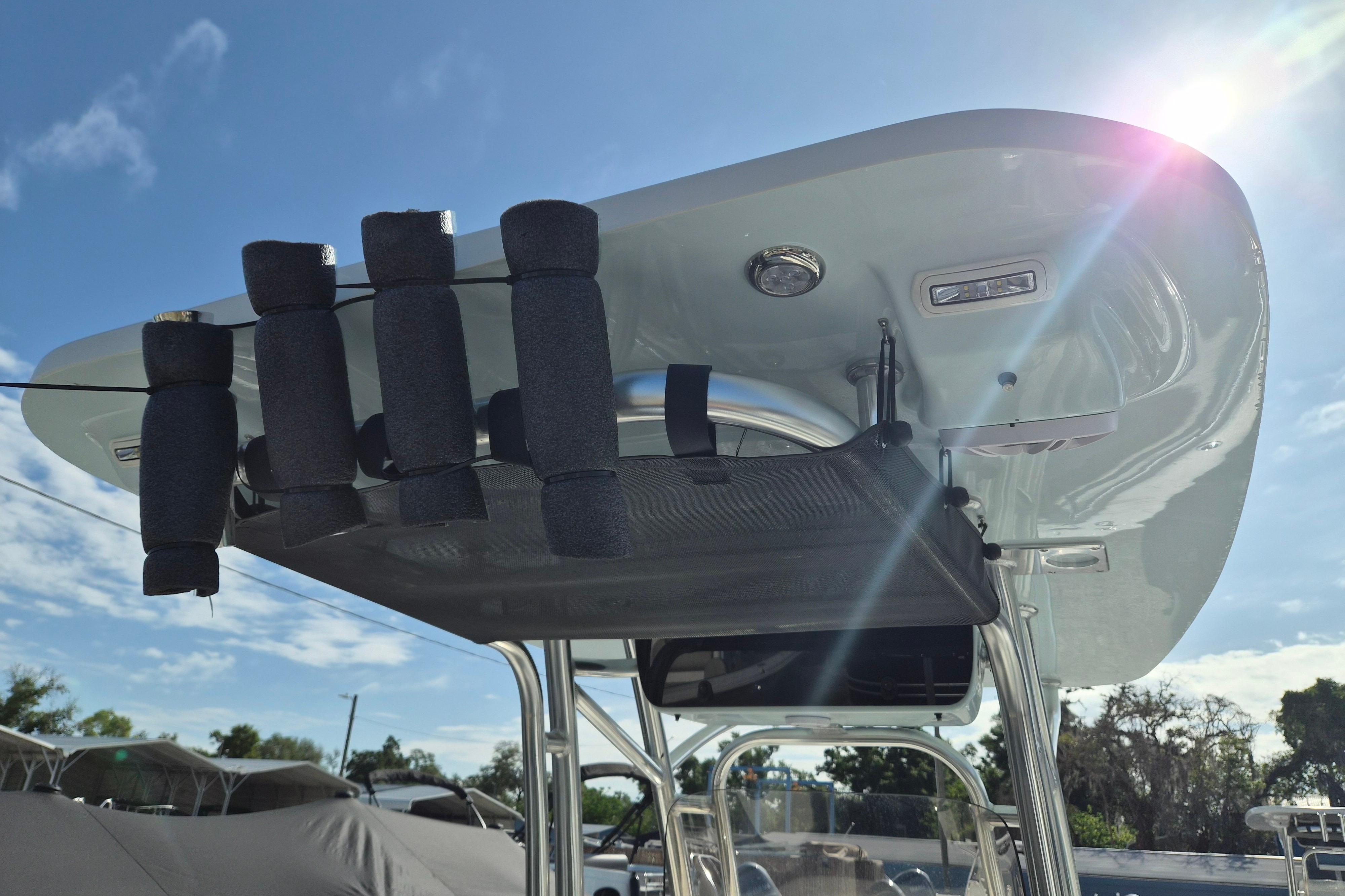 2026 Key West 239 FS boat with T-top and rod holders under sunny sky.