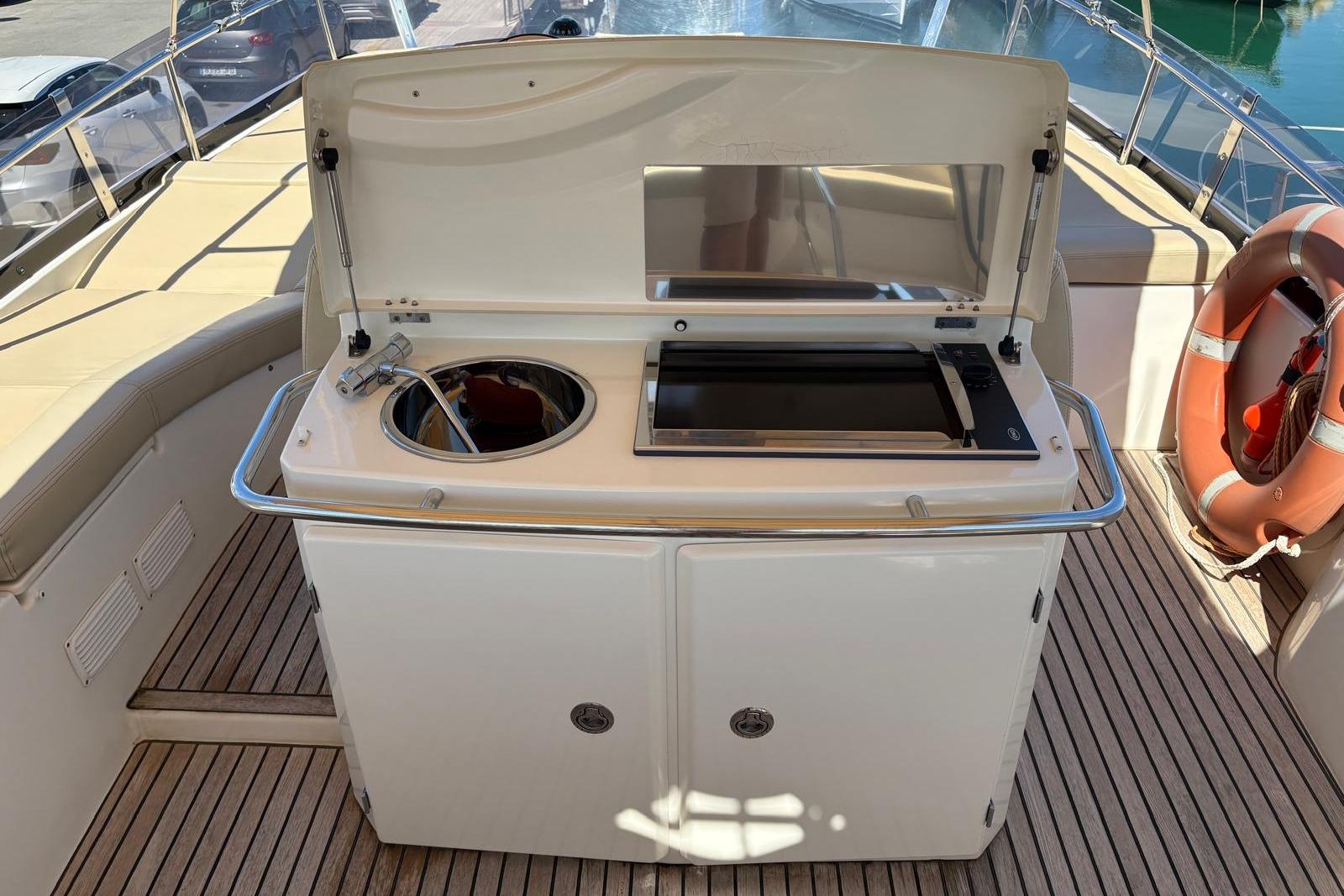 Outdoor kitchen on 2010 Jeanneau Prestige 50 yacht with sink and grill.