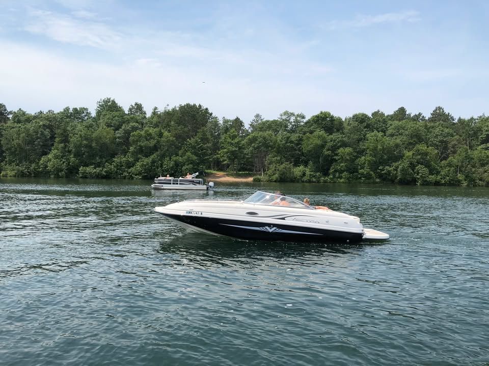 2008 Vectra 2402 IO boat on a calm lake.