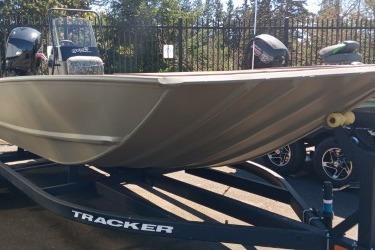 2026 Tracker Grizzly 2072 CC boat on trailer, outdoor setting.