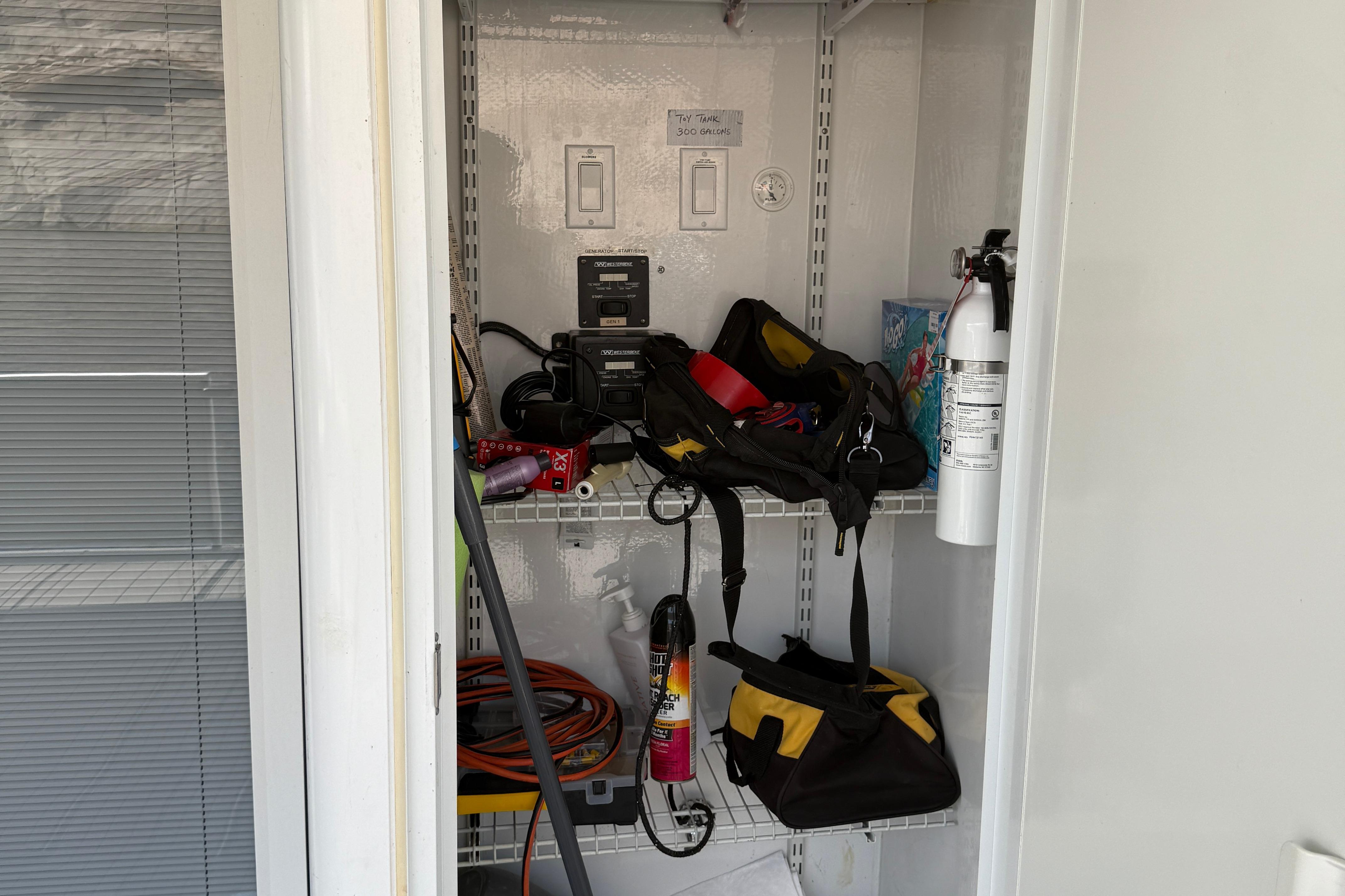 Storage closet with tools, fire extinguisher, and equipment. STARDUST Oceans Share #2, 2015.