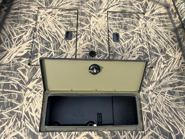 2024 Lowe Roughneck 1660 boat with open storage compartment and camo pattern.