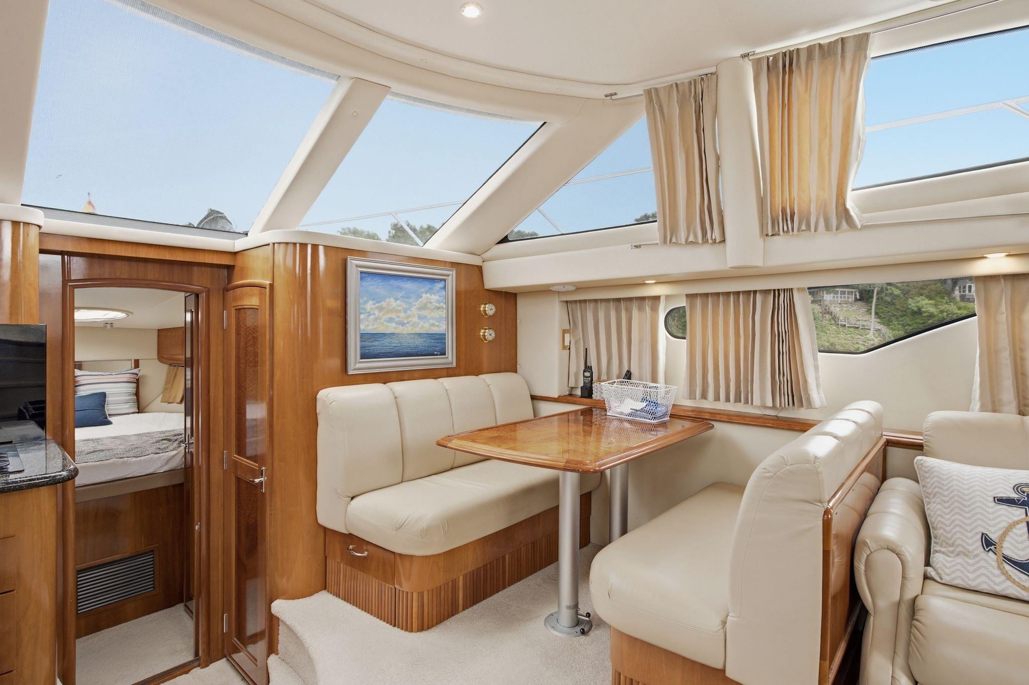 Luxurious interior of 2005 Carver 39 Motor Yacht with elegant seating and skylights.