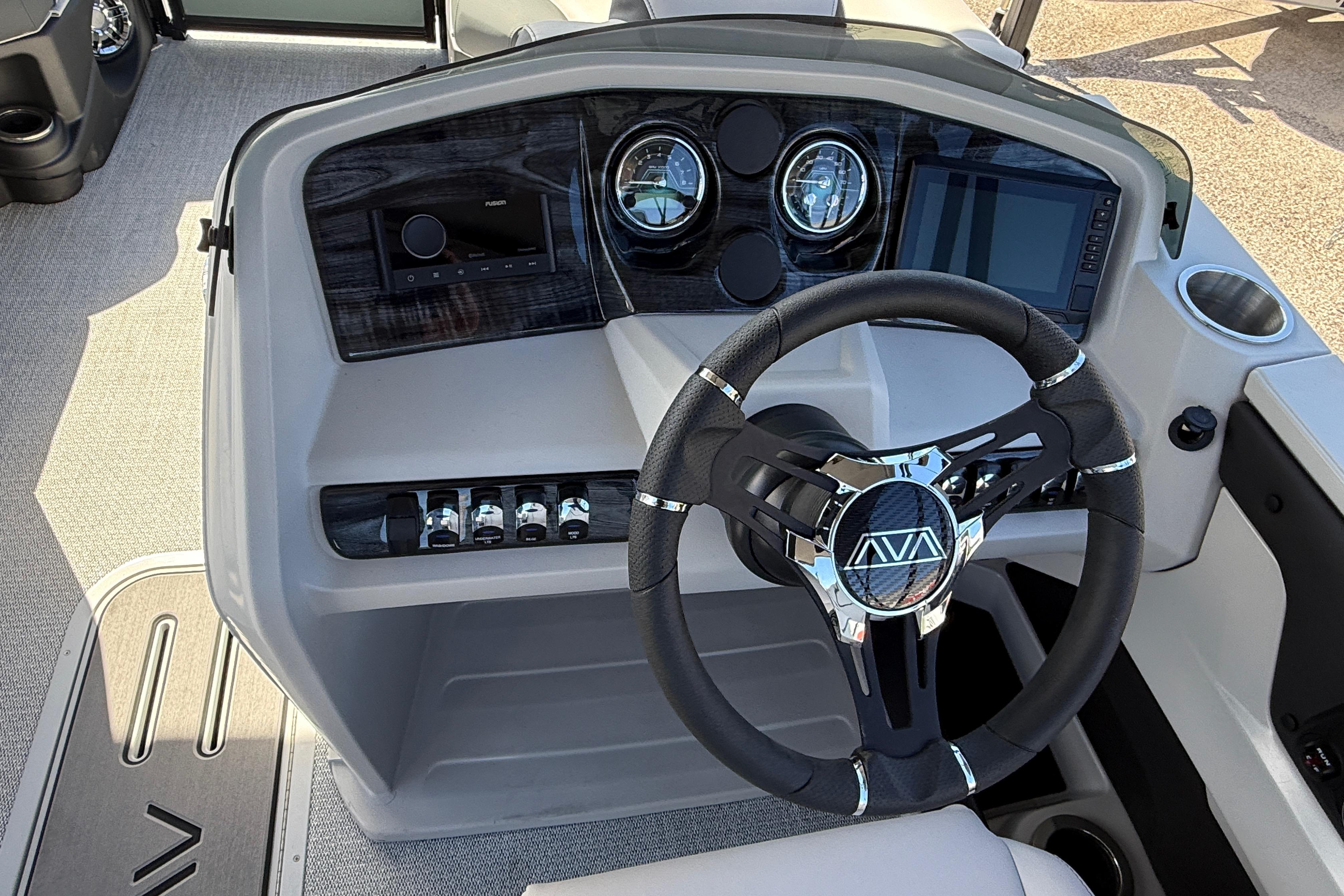 Steering console of 2026 Avalon 2385 LSZ Quad Lounger Tri Toon boat, featuring modern controls.