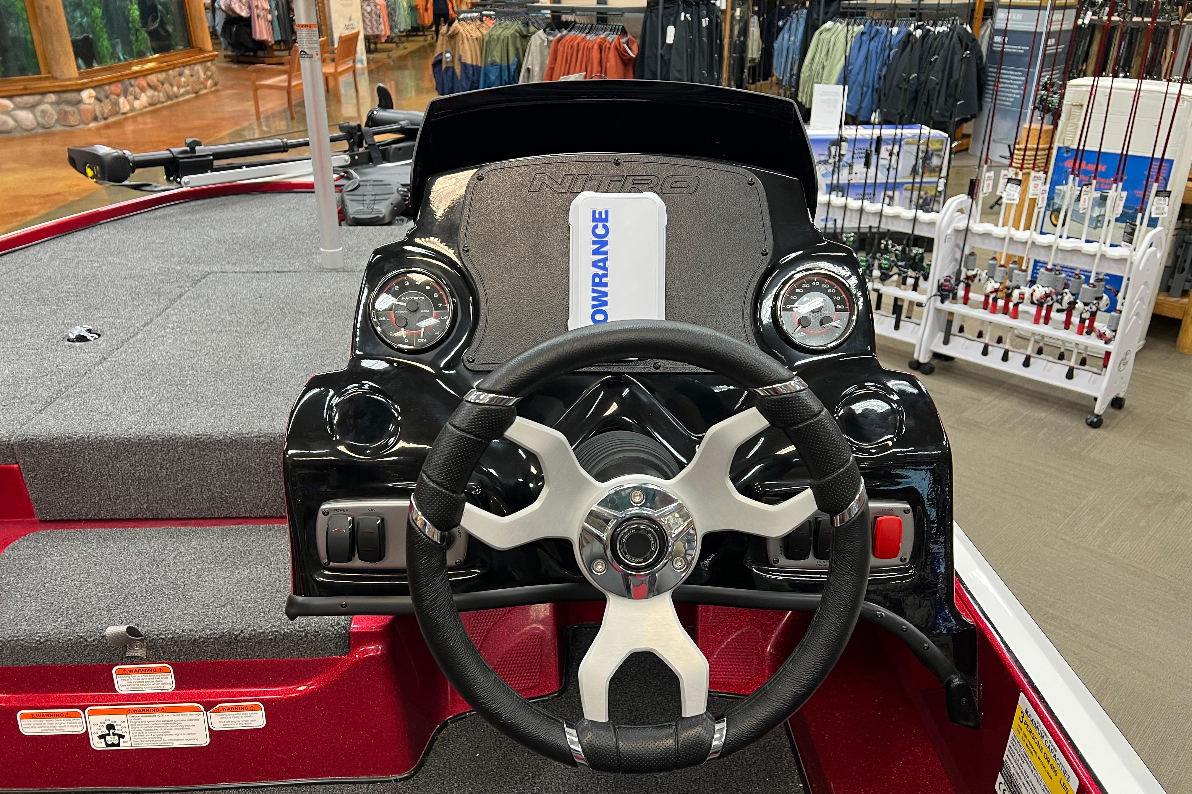 Steering console of a 2026 Nitro Z17 boat, featuring gauges and controls in a showroom.