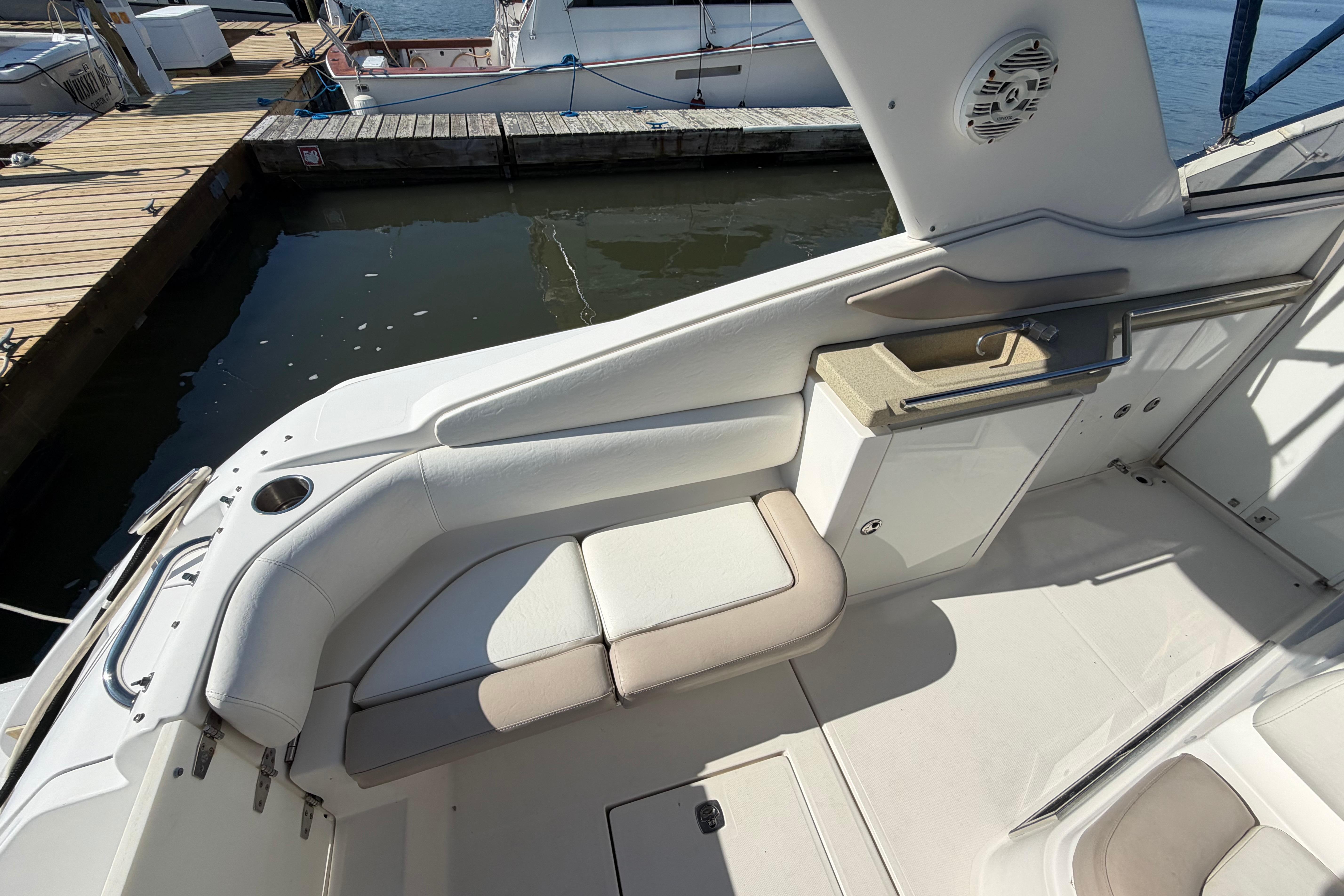 2003 Regal Commodore 3260 boat interior with seating and sink, docked at marina.