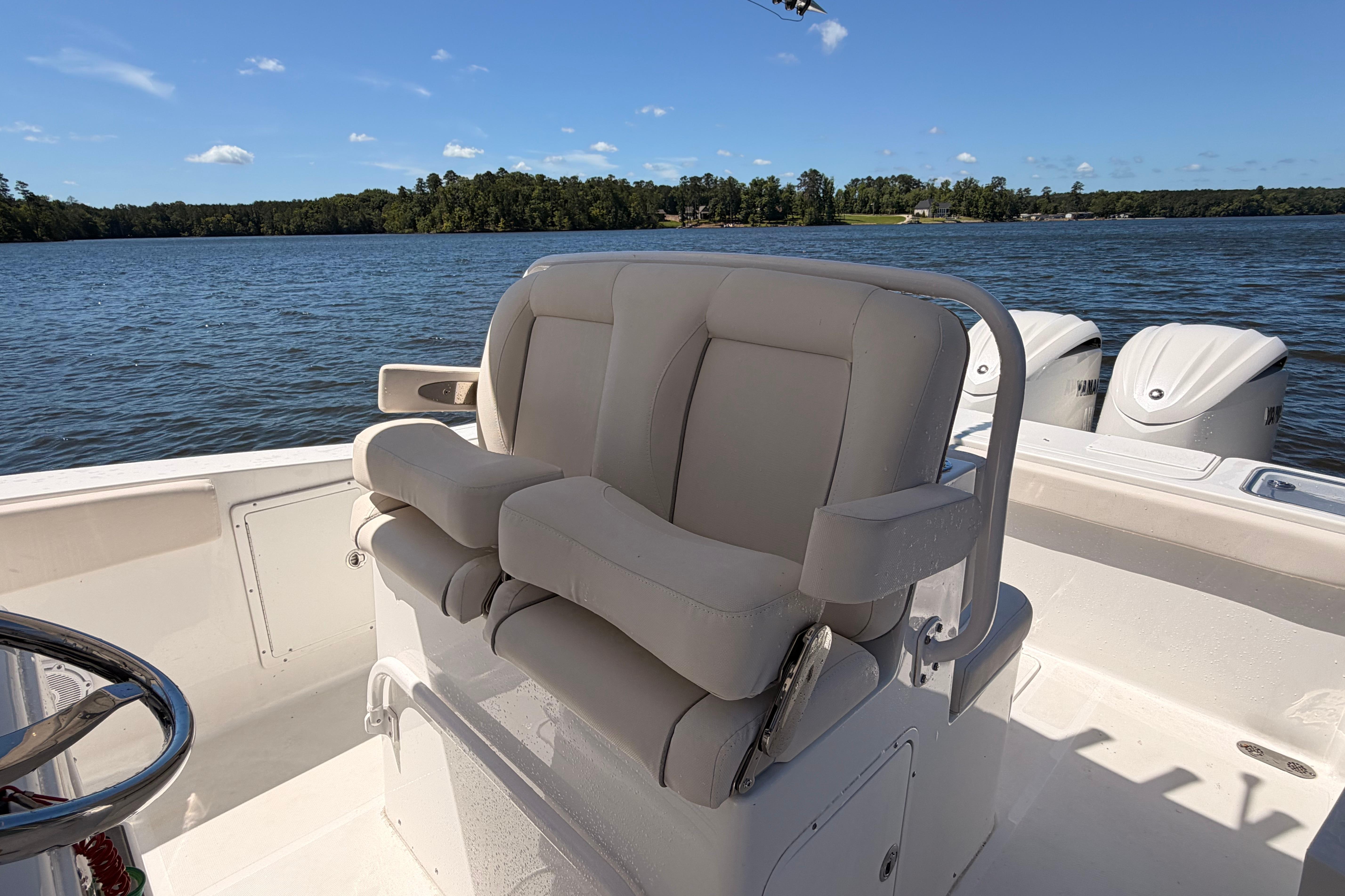 2024 Sea Hunt Gamefish 27 Coffin Box boat interior with comfortable seating and scenic water view.