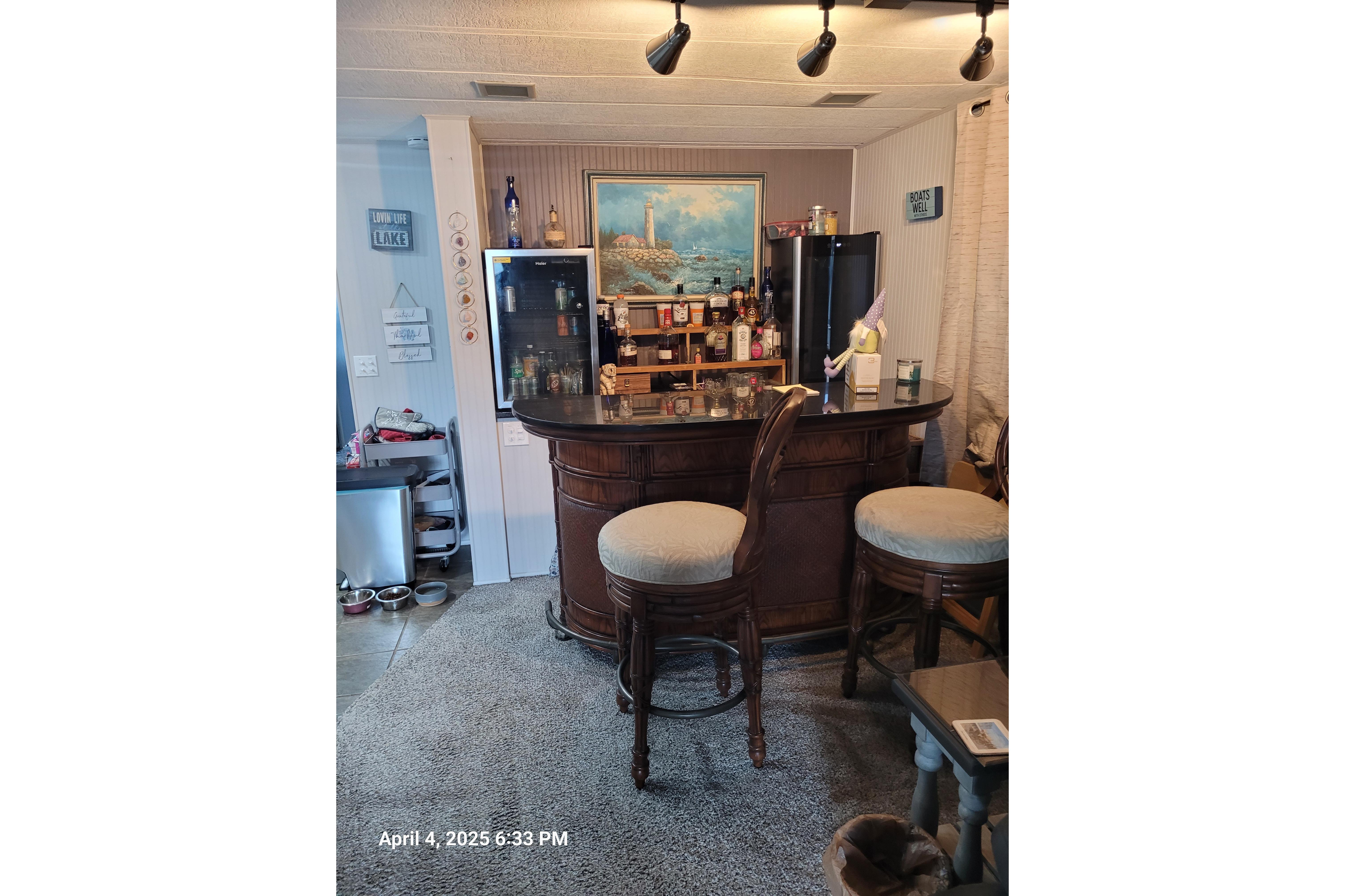 Cozy bar area in a 1990 Sumerset 16 x 70 houseboat with stools and decor.
