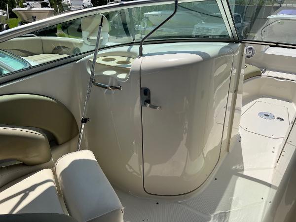 2005 Sea Ray 220 Sundeck interior with seating and windshield, showcasing elegant design.