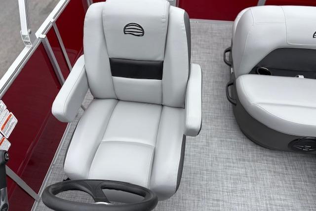 2026 Sun Tracker Party Barge 18 DLX interior with gray seating and steering wheel.