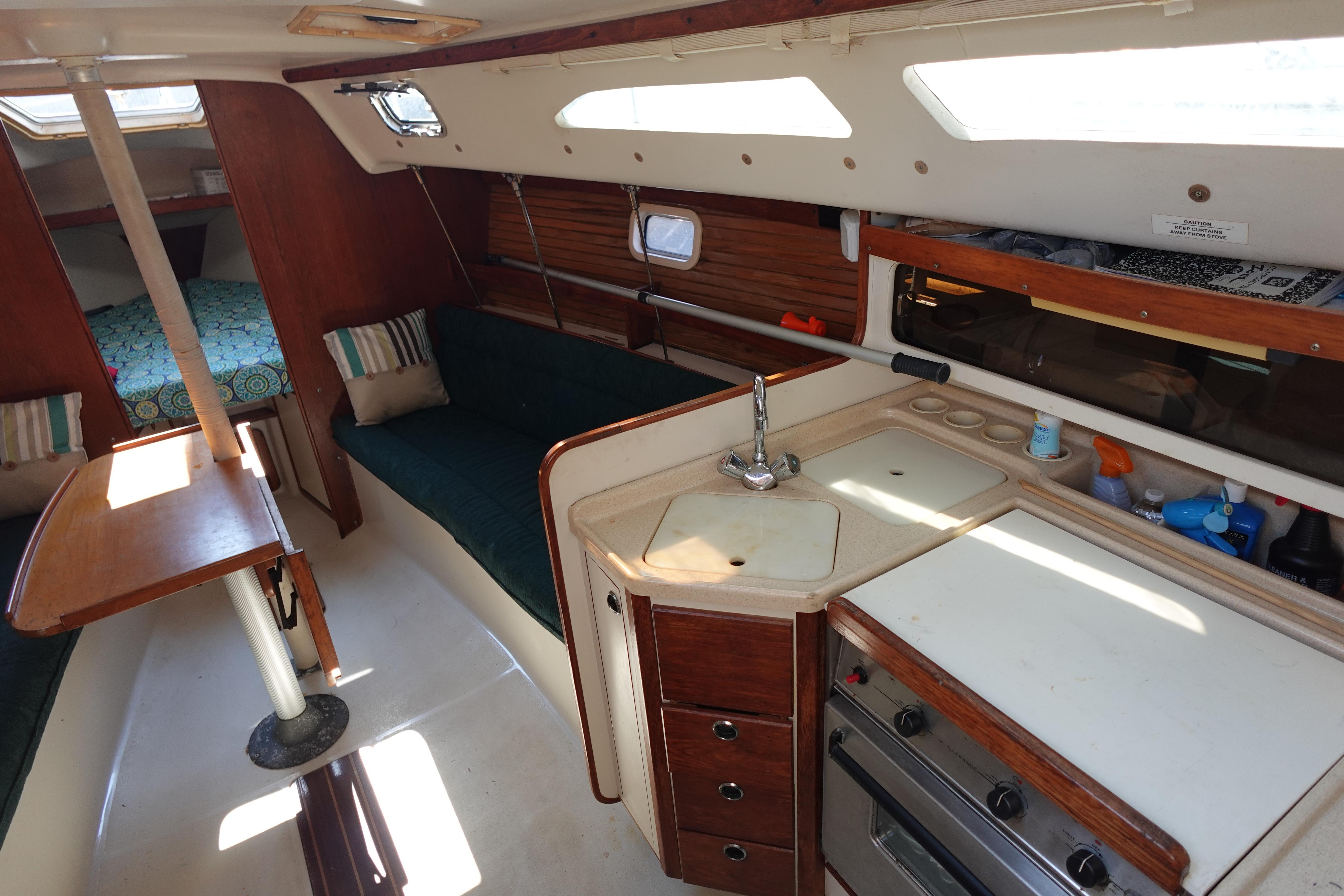 Interior of a 1997 Catalina 28 sailboat with kitchen and seating area.