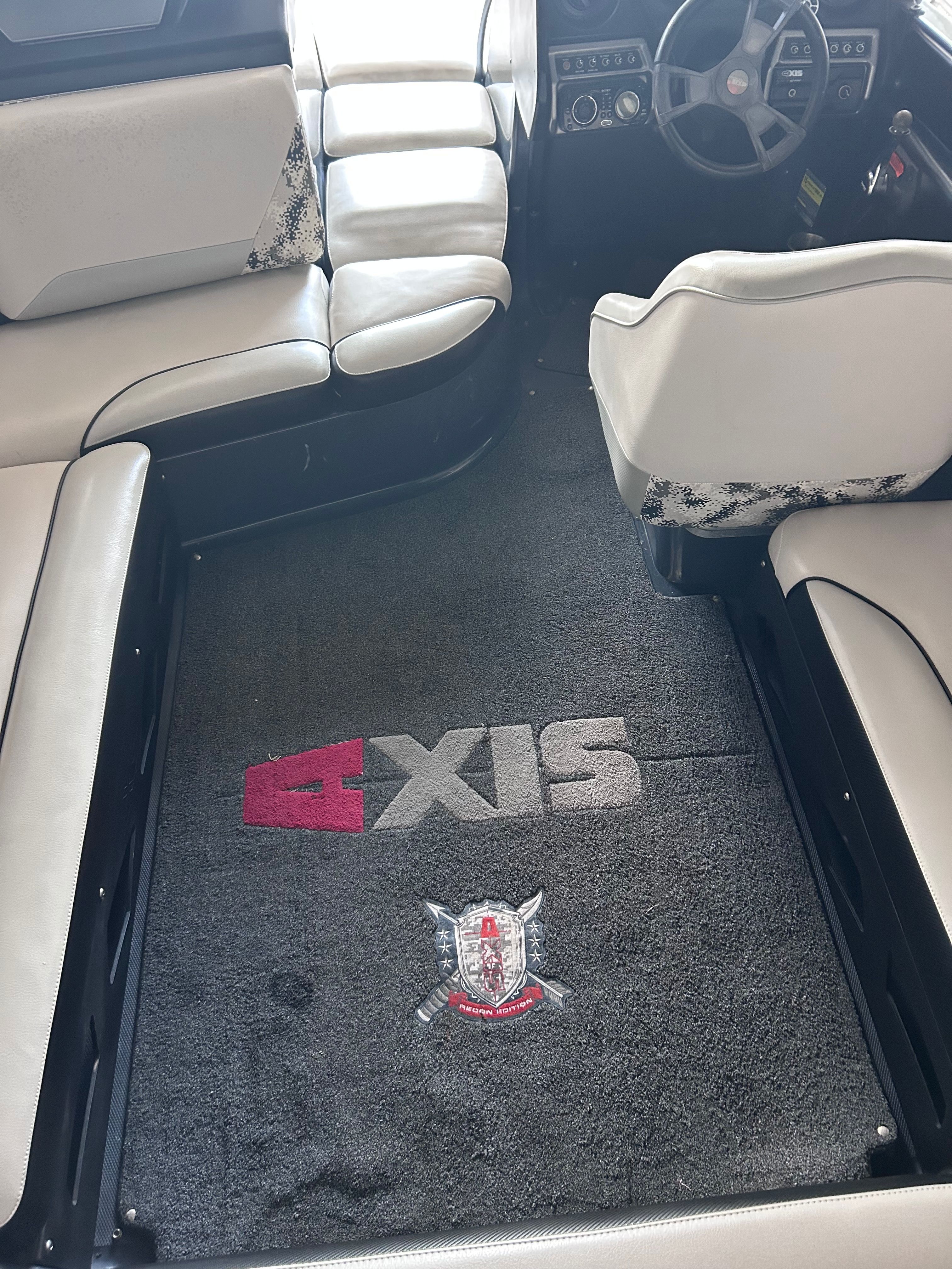 Interior of a 2013 Axis A22 boat with carpet flooring.