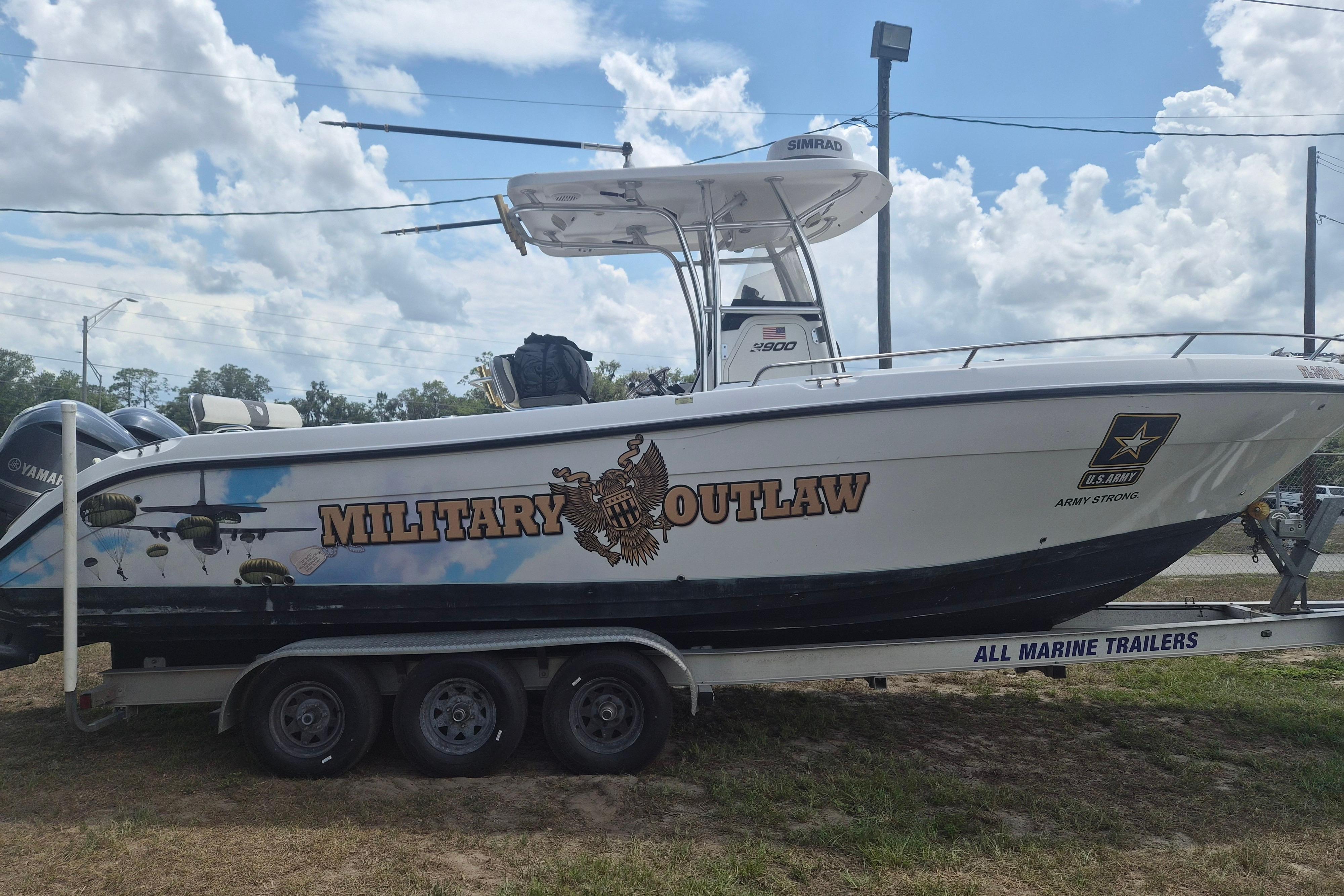 2006 Century 2900 Center Console boat with "Military Outlaw" graphics on trailer.