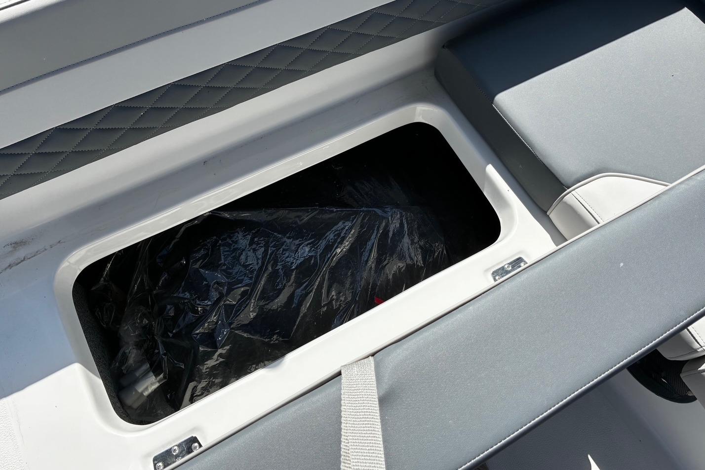 Storage compartment in 2026 Starcraft SVX 191 OB boat, featuring cushioned seating.
