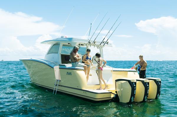 2019 Altima 38 Xcape boat with people enjoying a sunny day on the water.