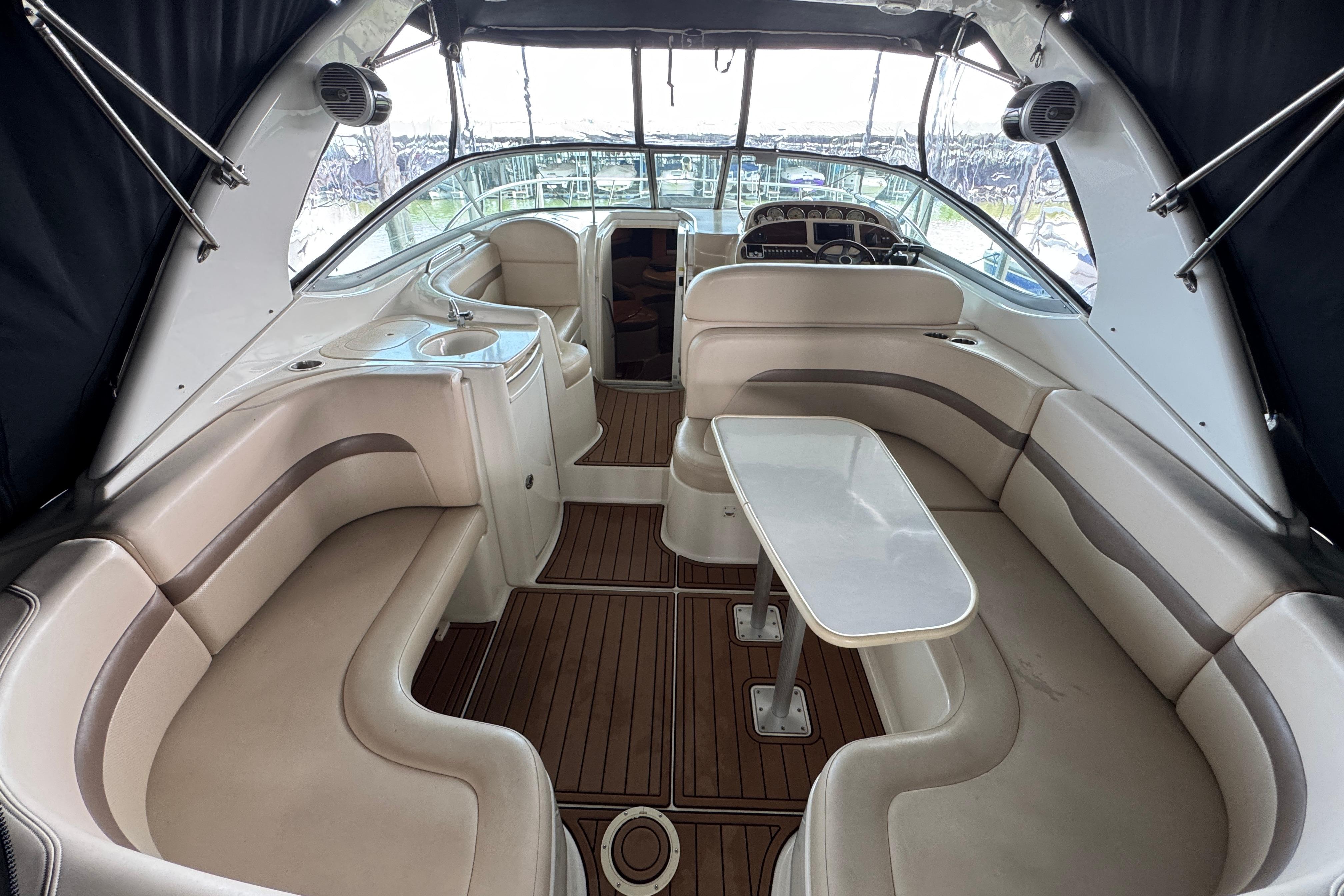 2006 Chaparral 330 Signature boat interior with plush seating and wooden flooring.
