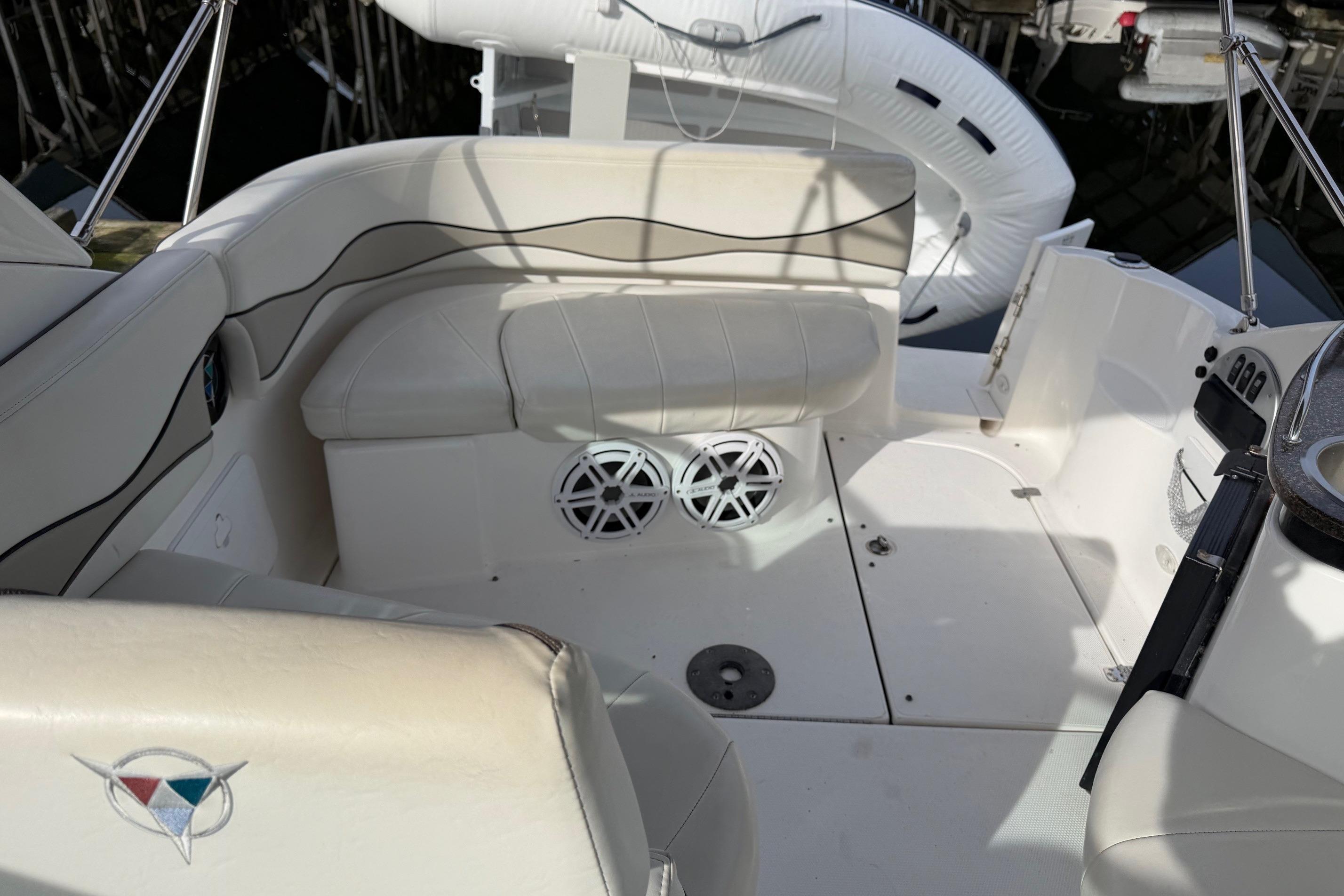 Interior of a 2008 Campion 925 LX boat with white seating and speaker system.
