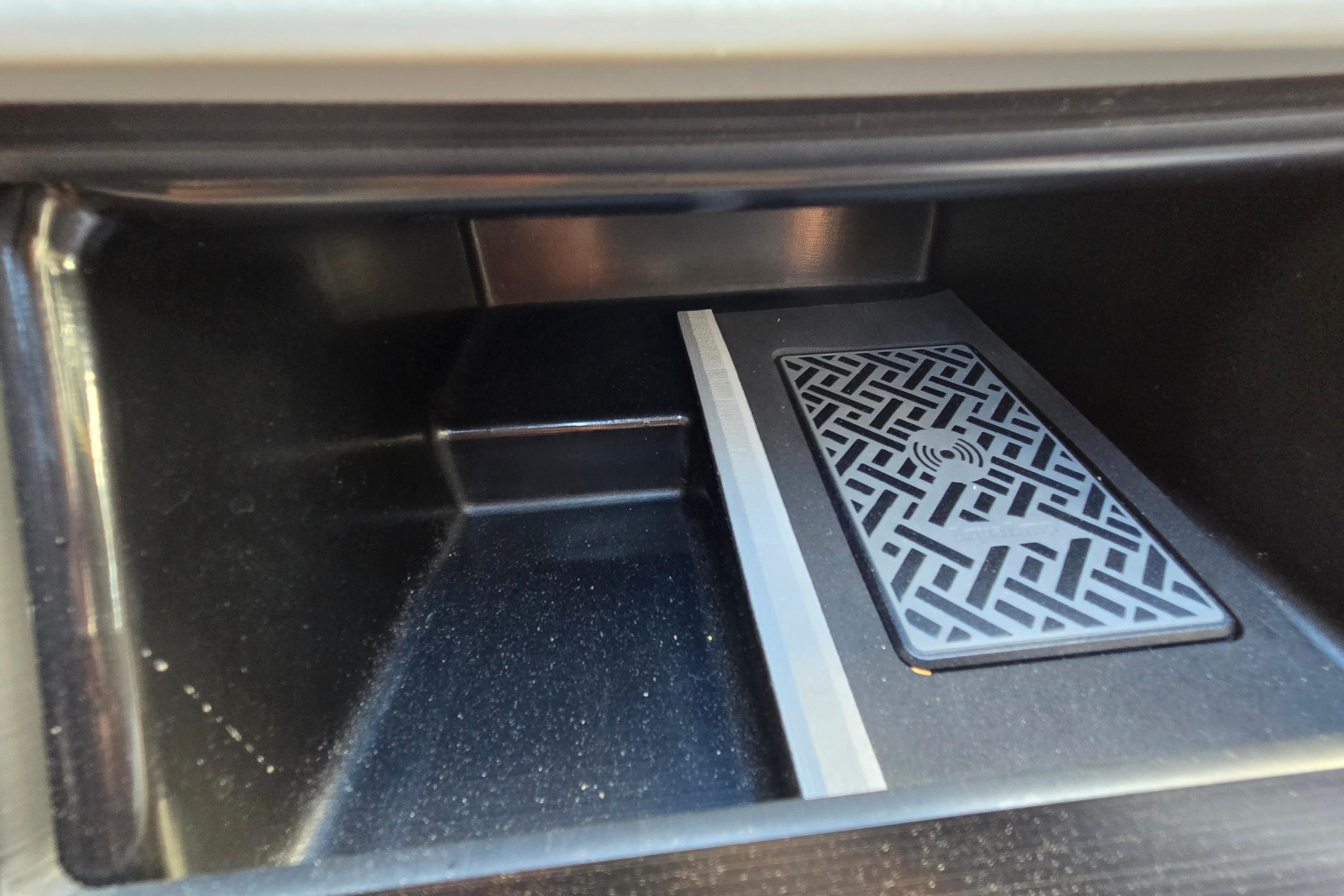Storage compartment with patterned mat in 2024 Godfrey Sweetwater 2486 SB boat.