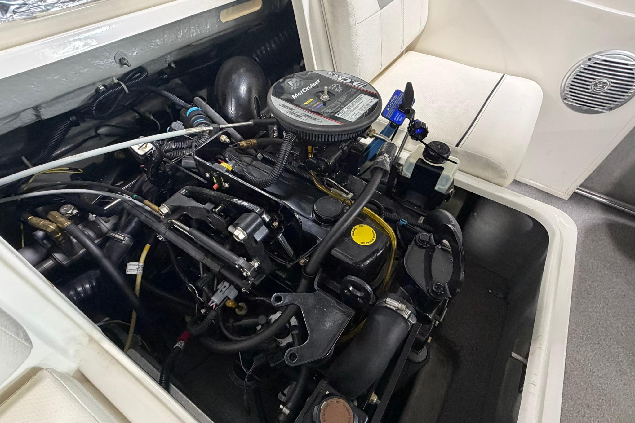Engine compartment of a 2012 Bayliner 175 Bowrider, showcasing detailed mechanical components.