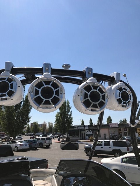 Speakers on a 2005 Malibu Open Wakesetter VLX boat in a parking lot.