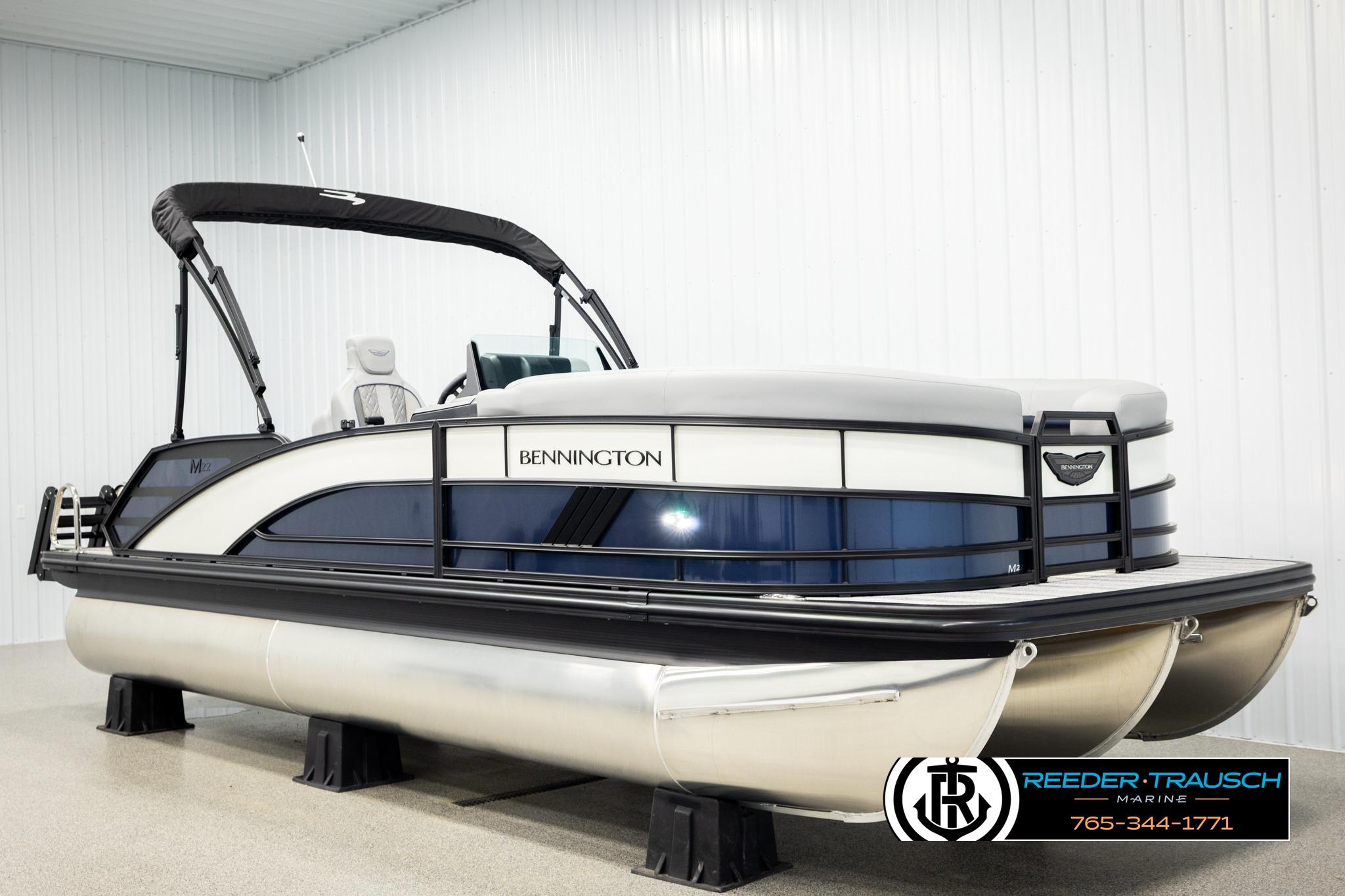 2026 Bennington 22 MSBSE pontoon boat in showroom, featuring sleek design and modern amenities.