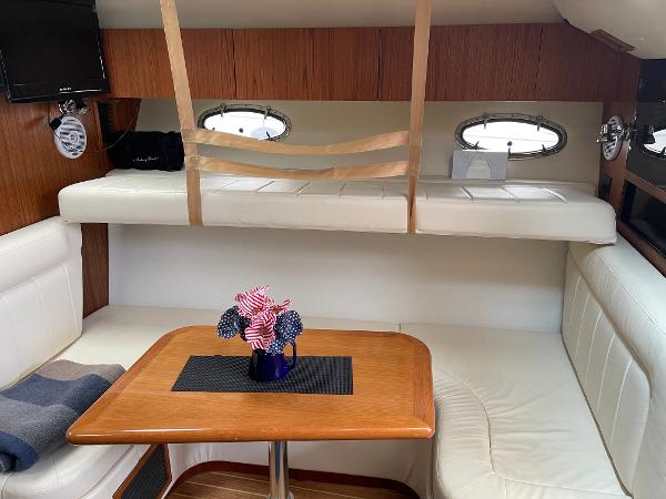 Interior of the 2003 Tiara Yachts 3500 Open with cozy seating area and table.