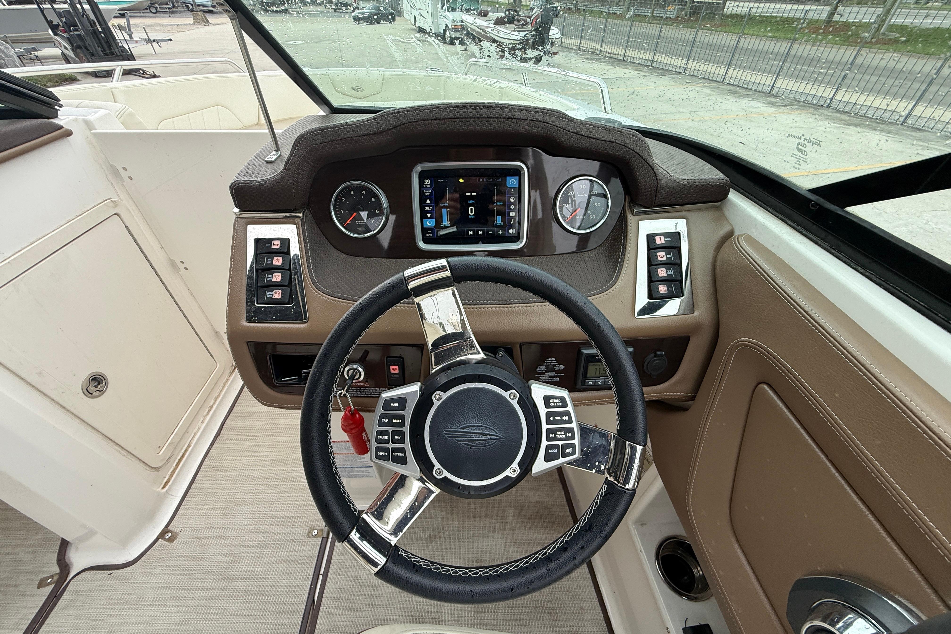 2018 Chaparral 227 SSX Surf boat dashboard with steering wheel and control panel.