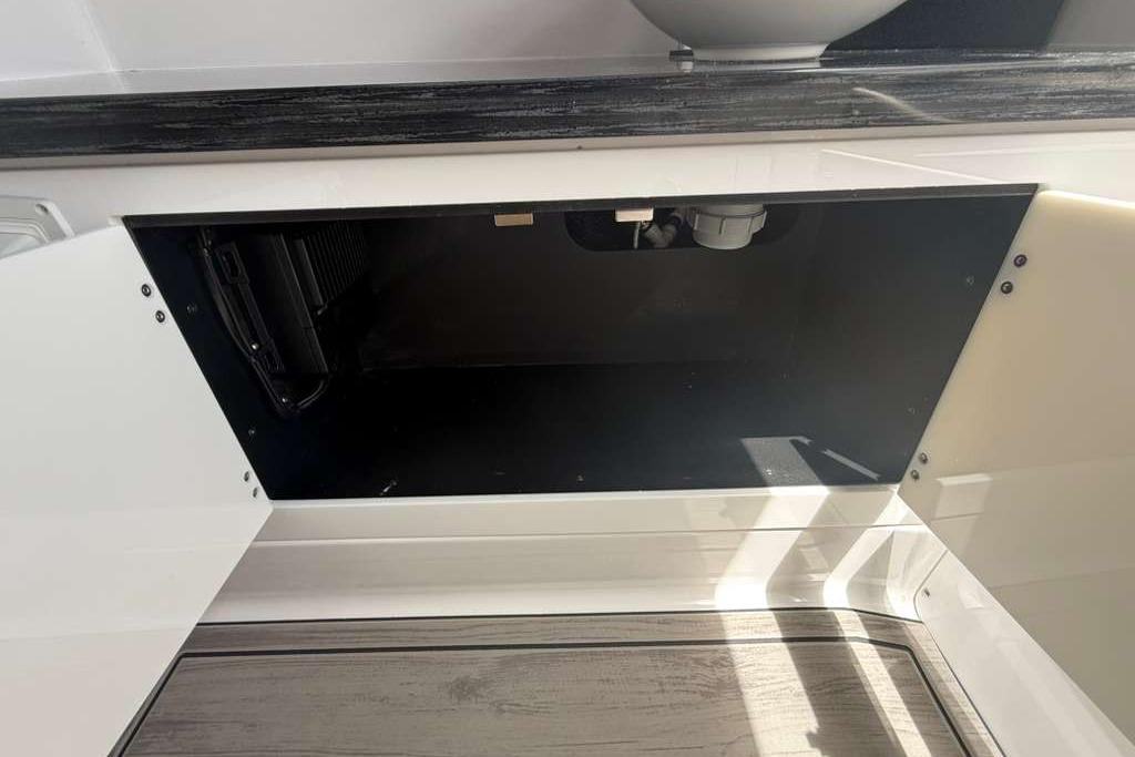 Open cabinet space in 2026 Monterey Elite 30 OB boat interior.