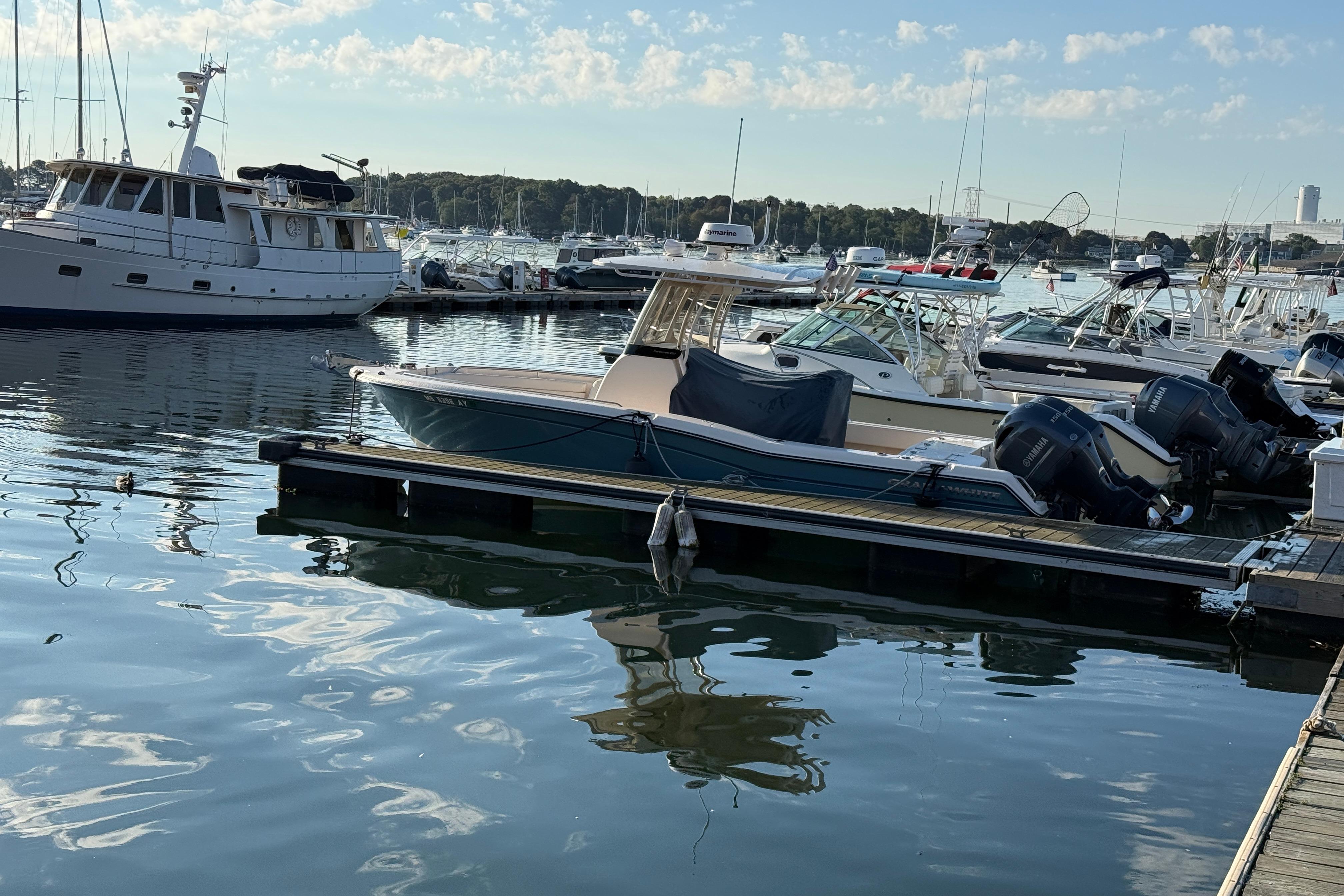 2017 Grady White 257 Fisherman boat docked in a marina with other vessels.