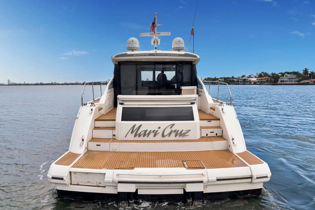 2012 Fairline Targa 58 yacht on water, rear view with wooden deck.