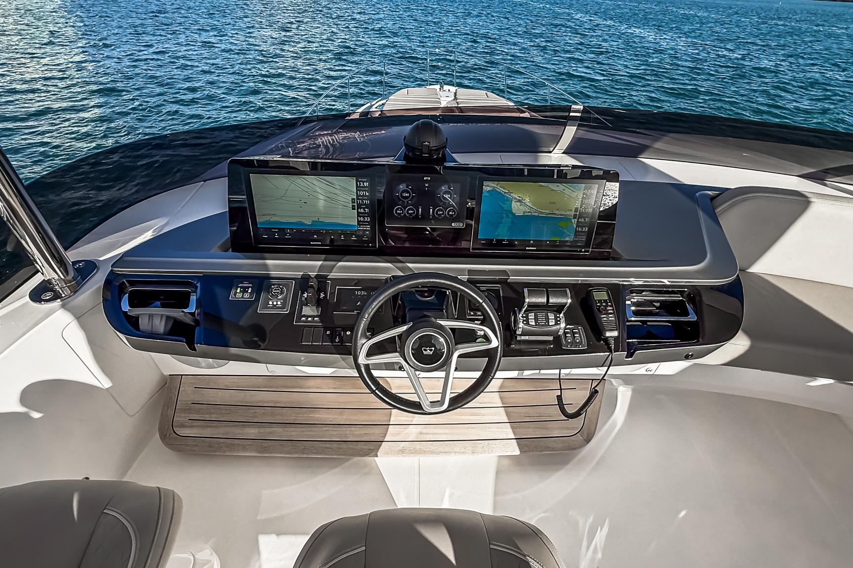 Helm of 2026 Princess S65 Sportbridge yacht with advanced navigation displays.